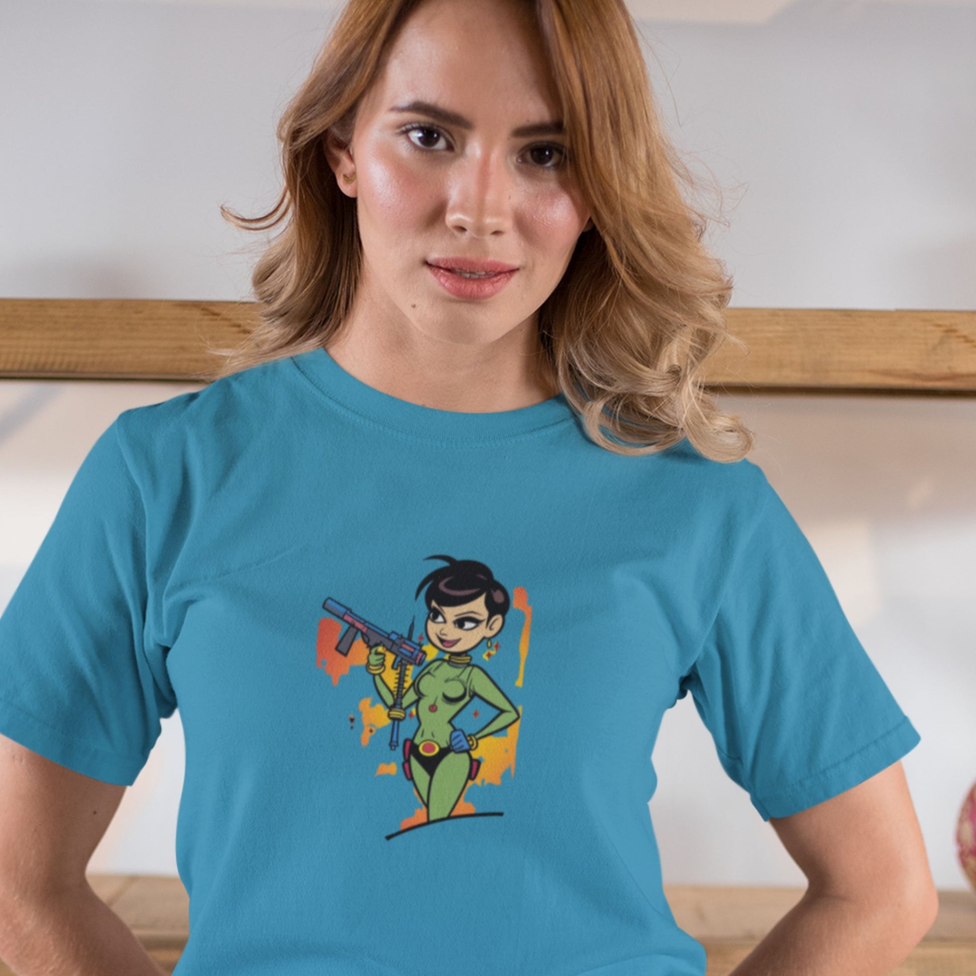 Woman wearing an aqua blue t-shirt with a fun, colorful cartoon illustration in a dojo.