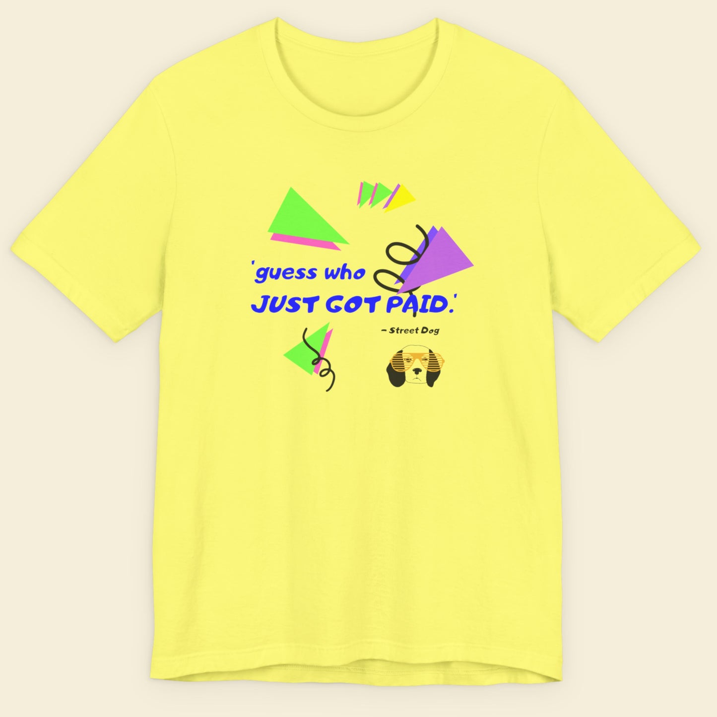 Yellow t-shirt with colorful graphics and text on a beige background.