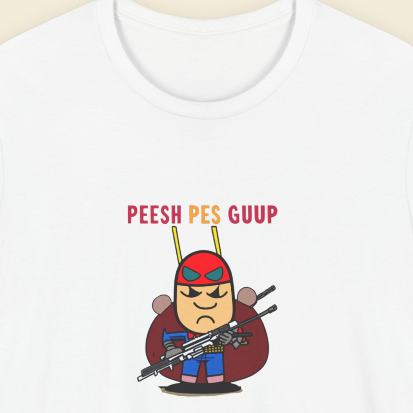 White t-shirt with a fun, colorful cartoon character illustration on a beige background.