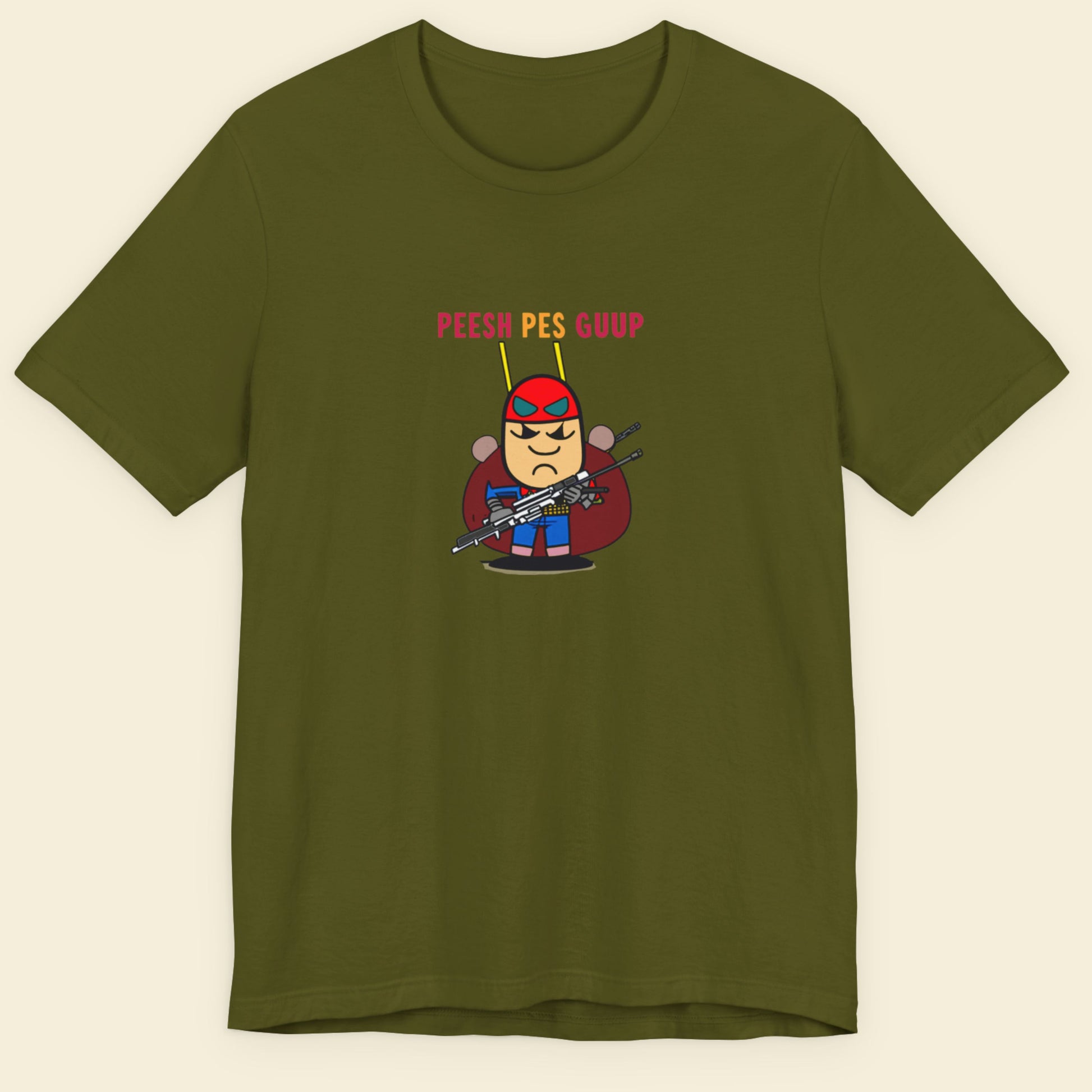 Green t-shirt with a fun, colorful cartoon character illustration on a beige background.