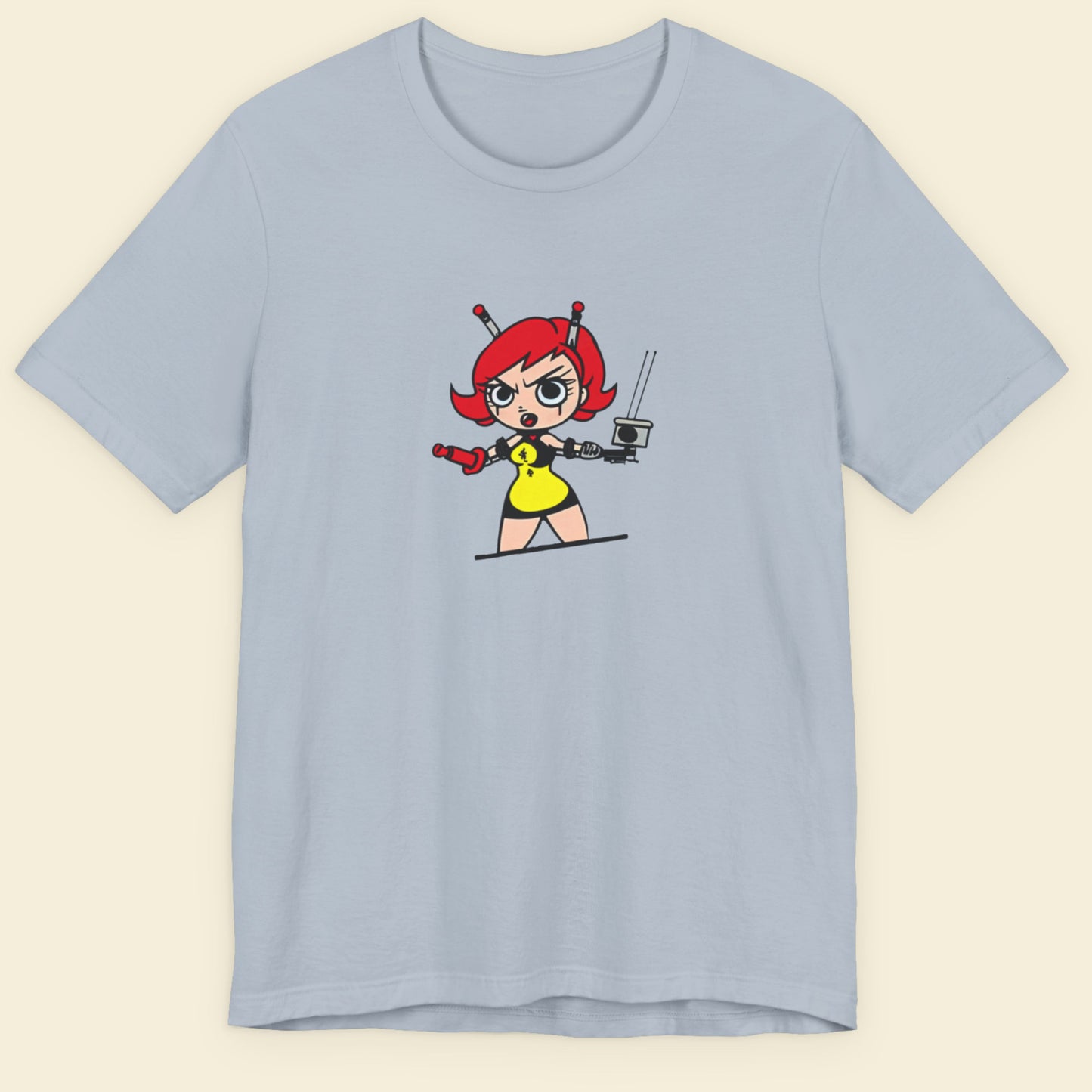 Light blue t-shirt with a fun, colorful cartoon illustration on a beige background.