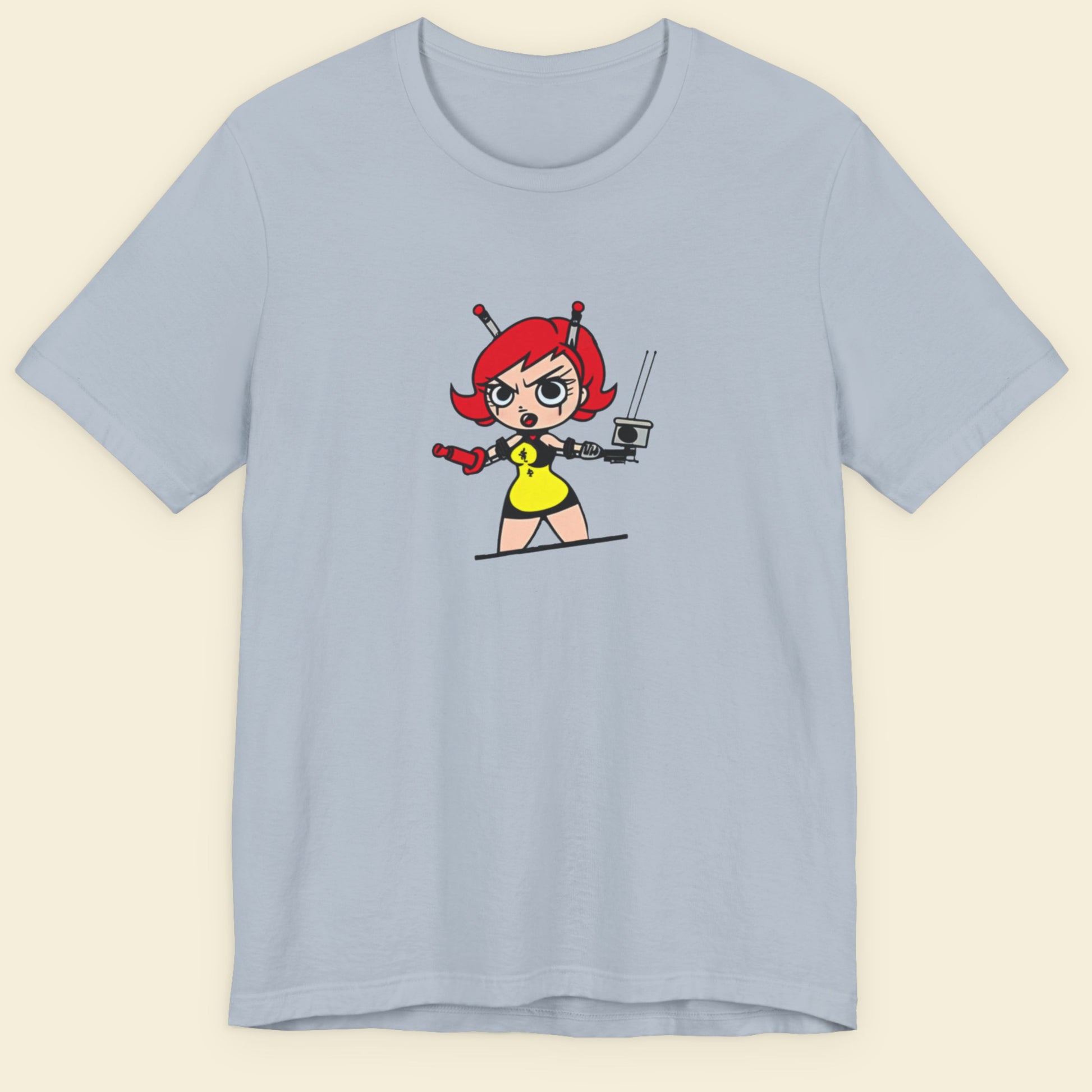 Light blue t-shirt with a fun, colorful cartoon illustration on a beige background.