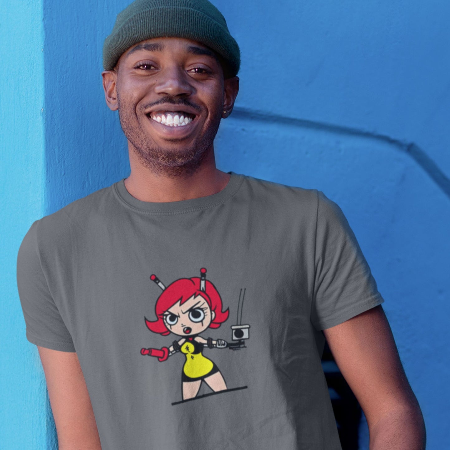 Smiling man wearing a grey t-shirt with a fun, colorful cartoon illustration on a blue background.