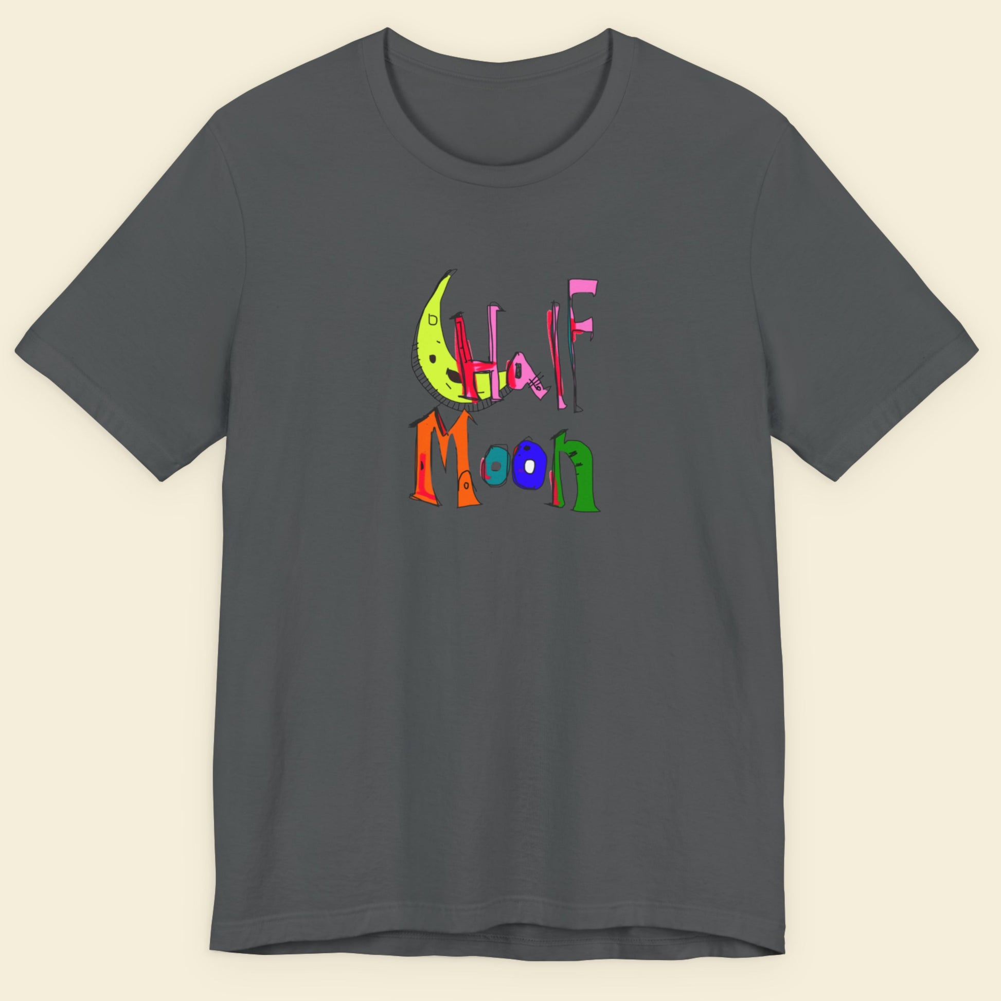 Gray t-shirt with colorful 'Half Moon' design on a beige background.