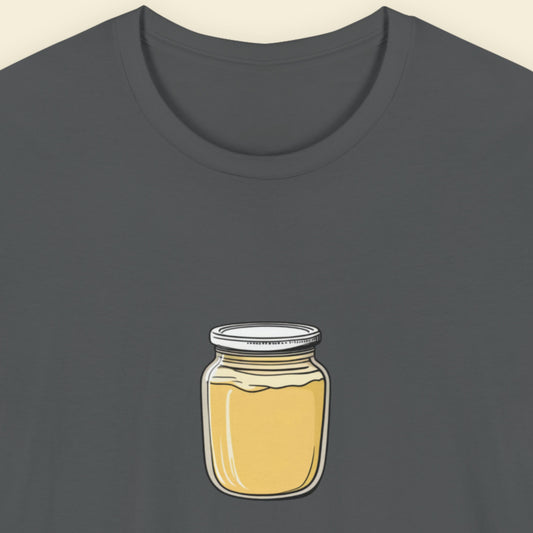 Grey t-shirt with a drawing of a jar of Dijon mustard on a beige background.