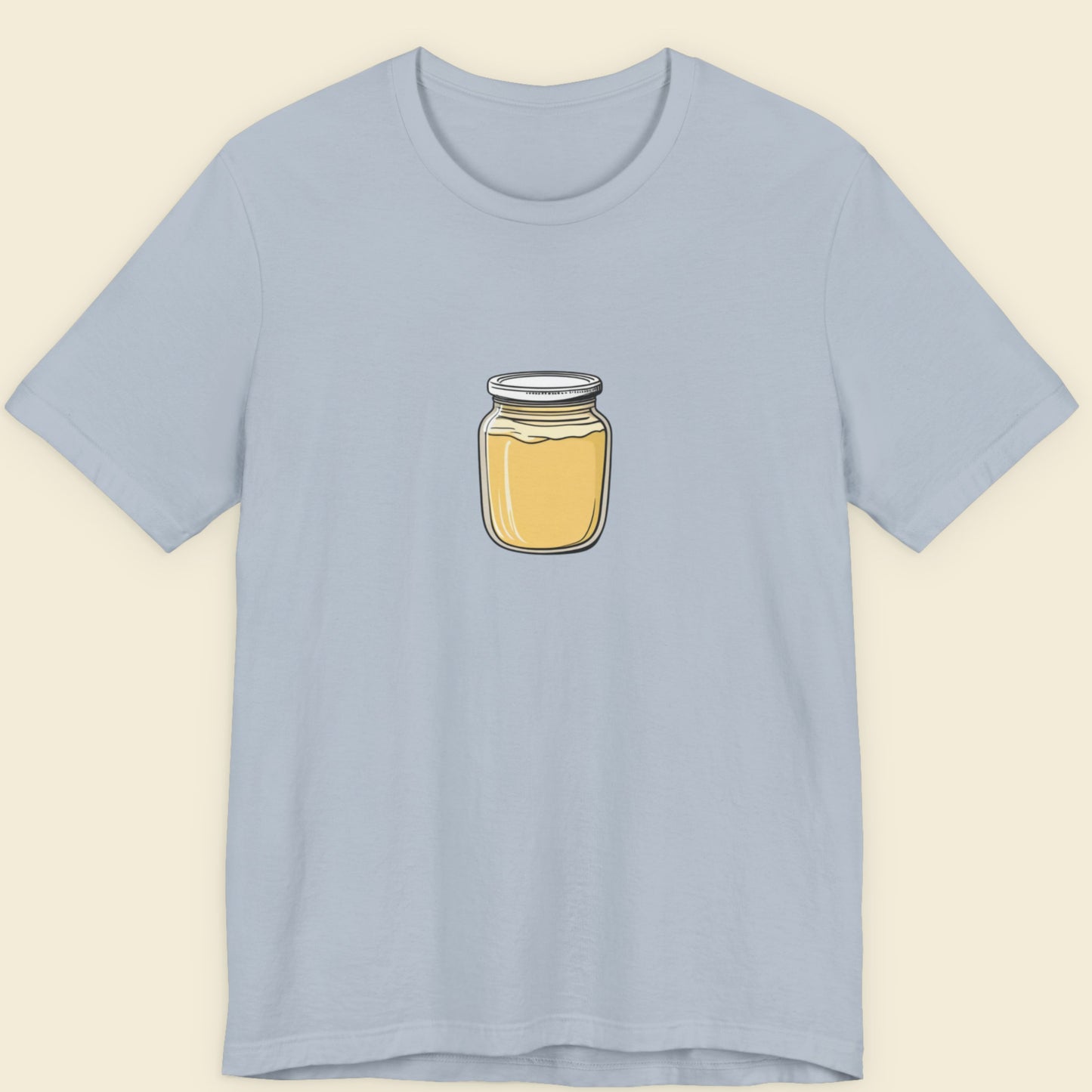 Light blue t-shirt with a jar of Dijon mustard graphic on a beige background