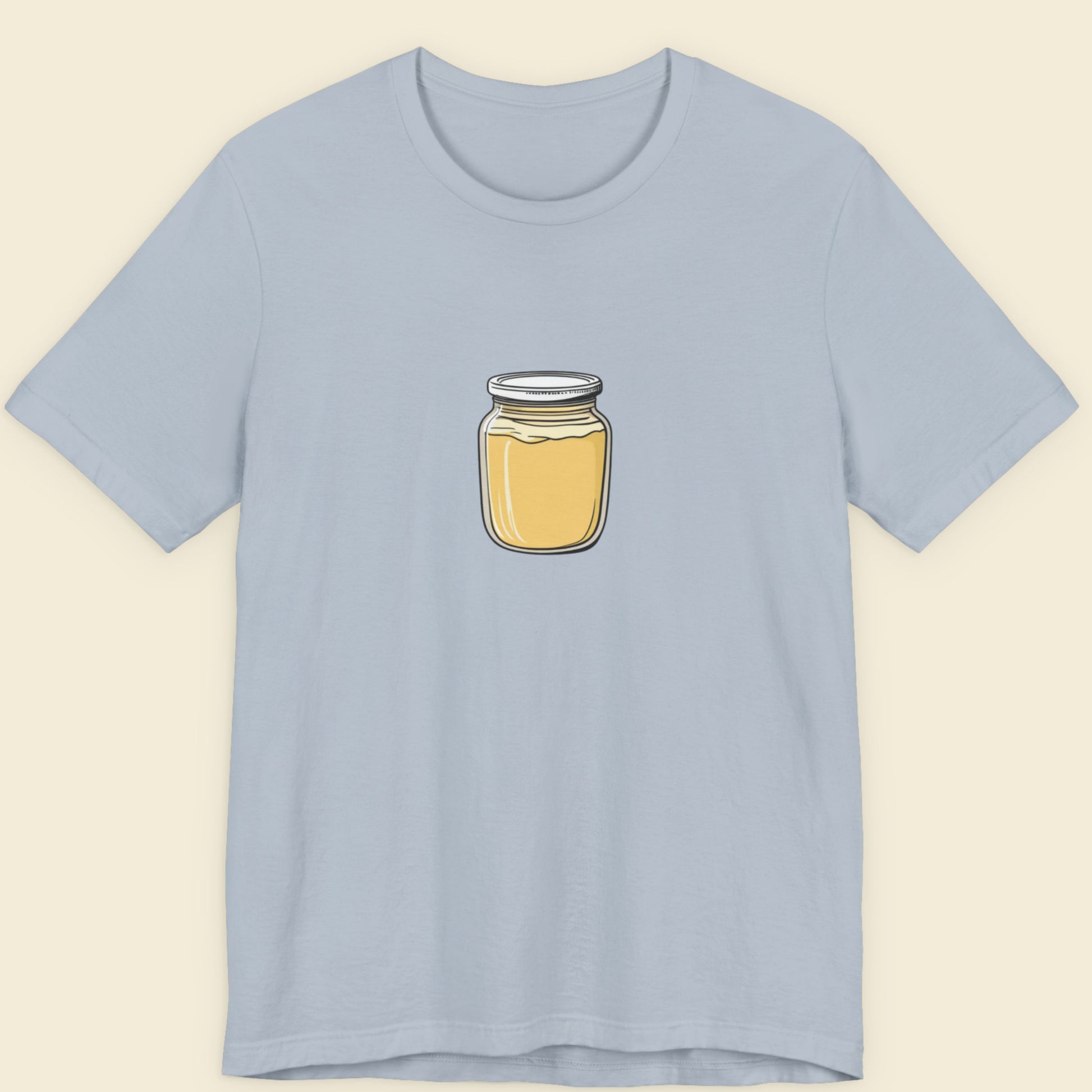 Light blue t-shirt with a jar of Dijon mustard graphic on a beige background