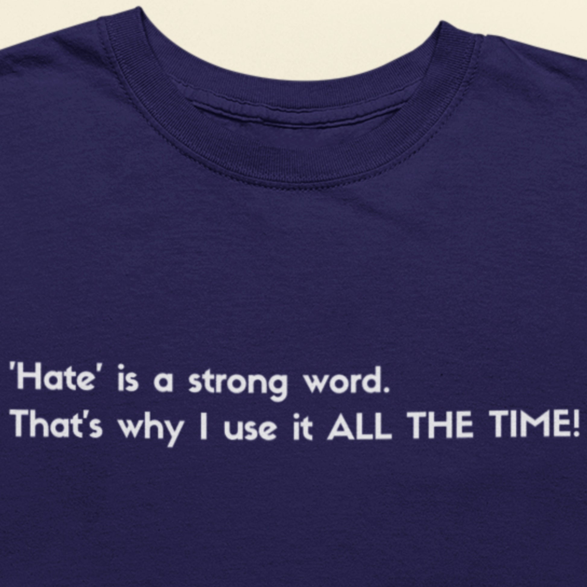Navy blue t-shirt with white text on a beige background