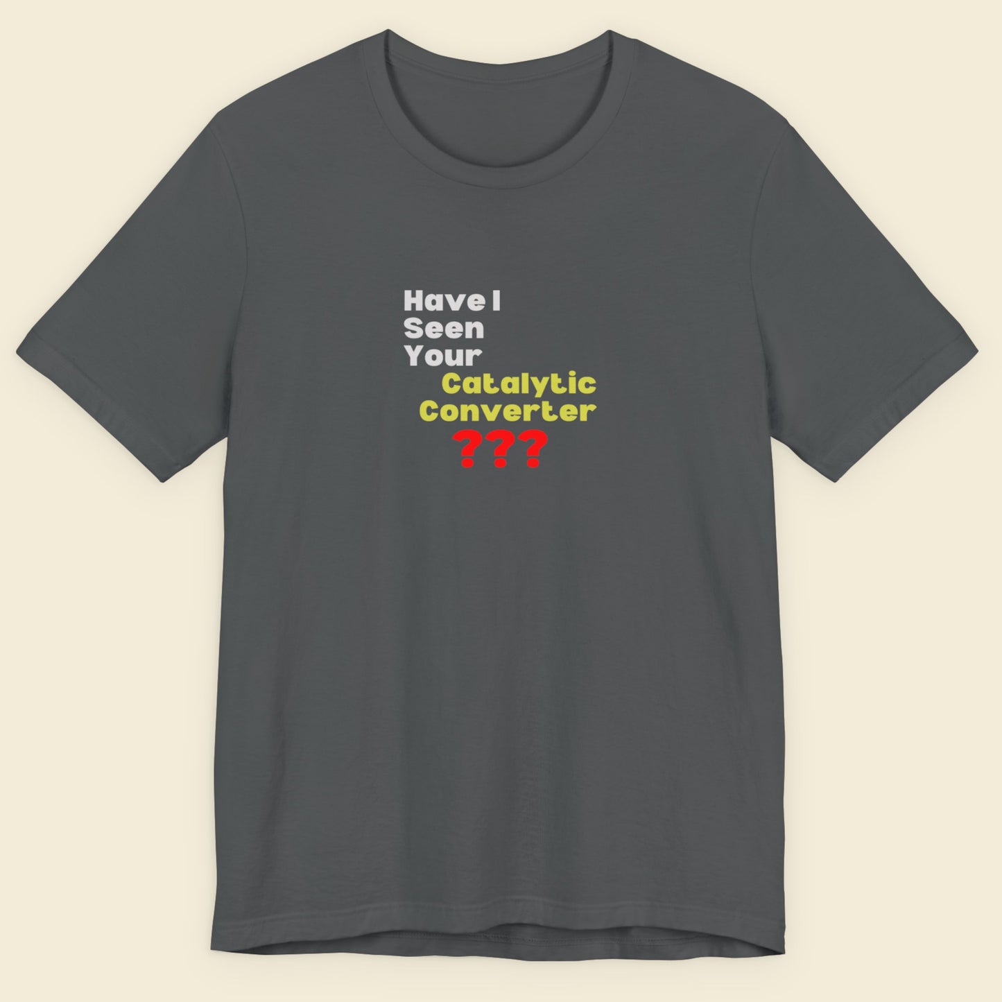 Gray t-shirt with humorous text design on a beige background.