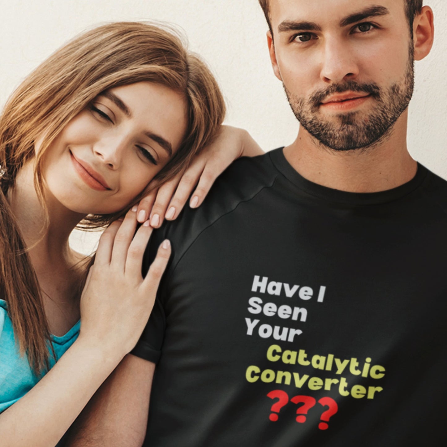 Man wearing a black t-shirt with humorous text, standing next to a woman.