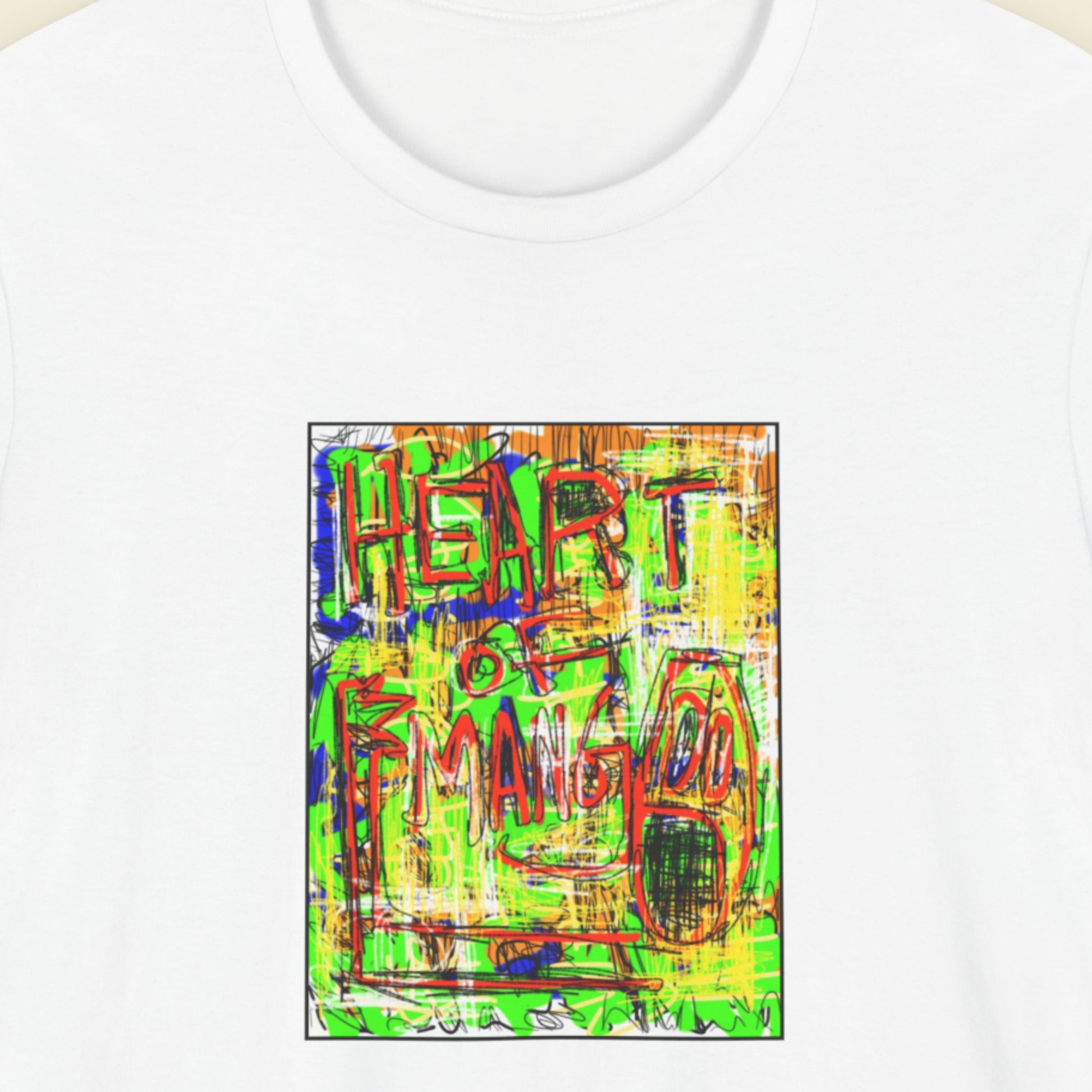 White t-shirt with colorful graphic design featuring the text 'Heart of Mango' on a beige background.