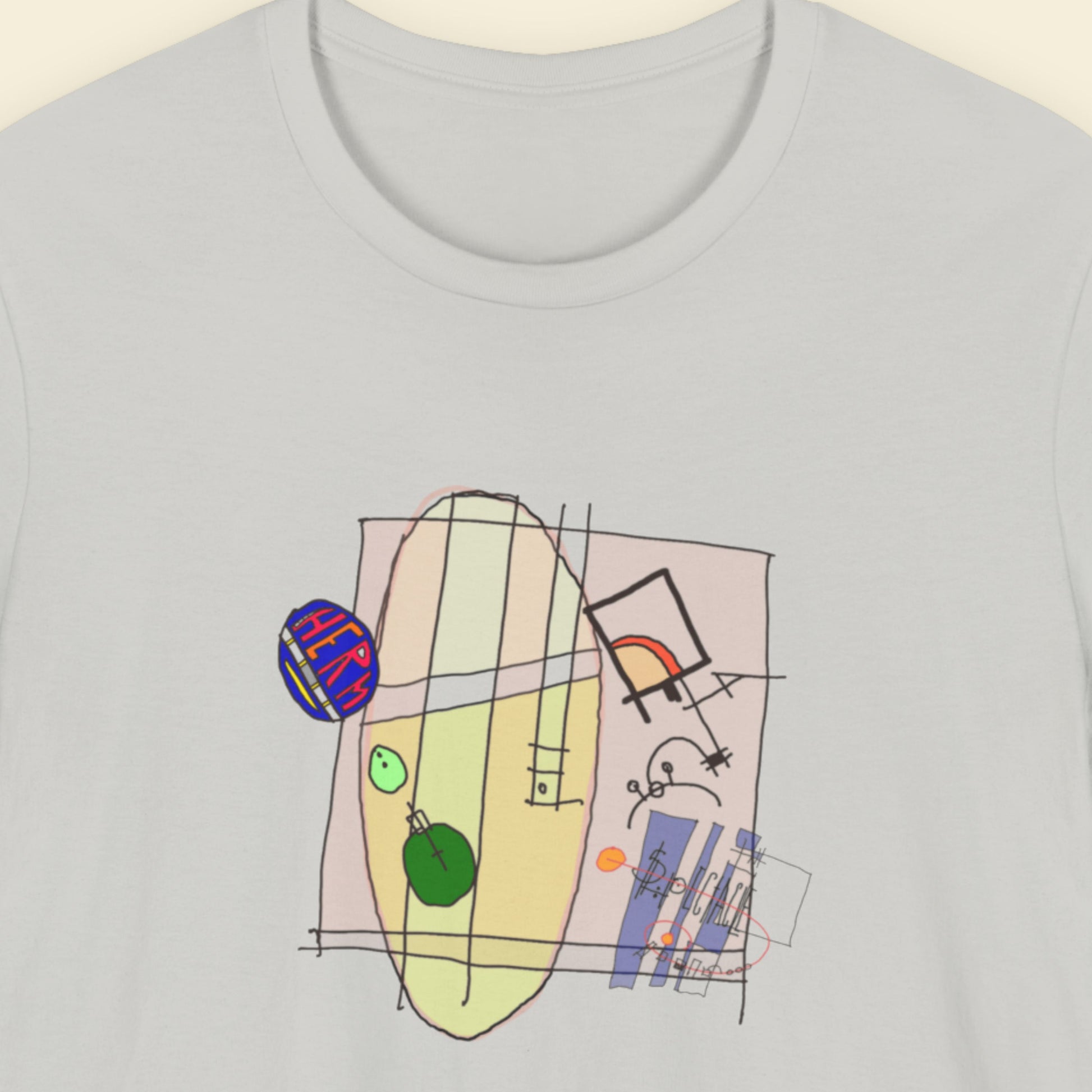 Grey t-shirt with a colorful abstract system drawing on a beige background.