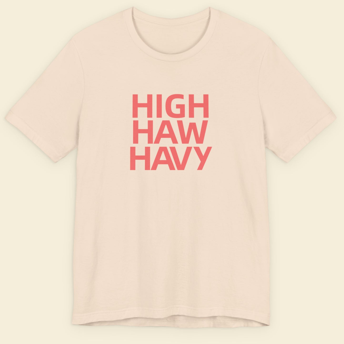 Beige t-shirt with multicolored nonsensical  'high haw havy' text on a beige background.