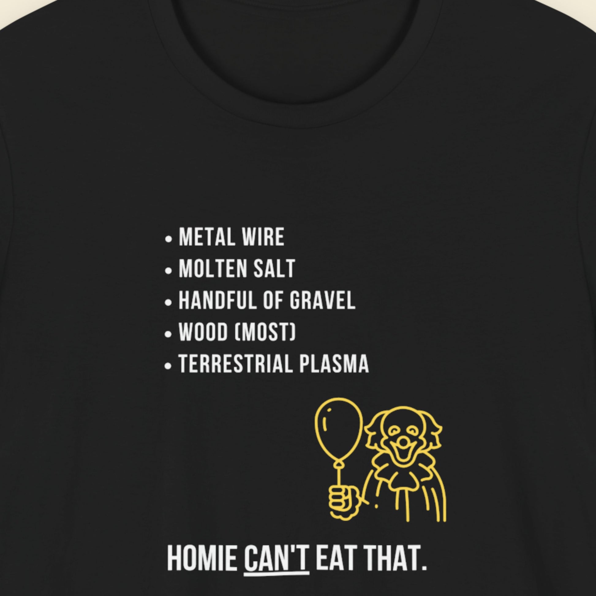 Black t-shirt with humorous colorful text on a beige background.