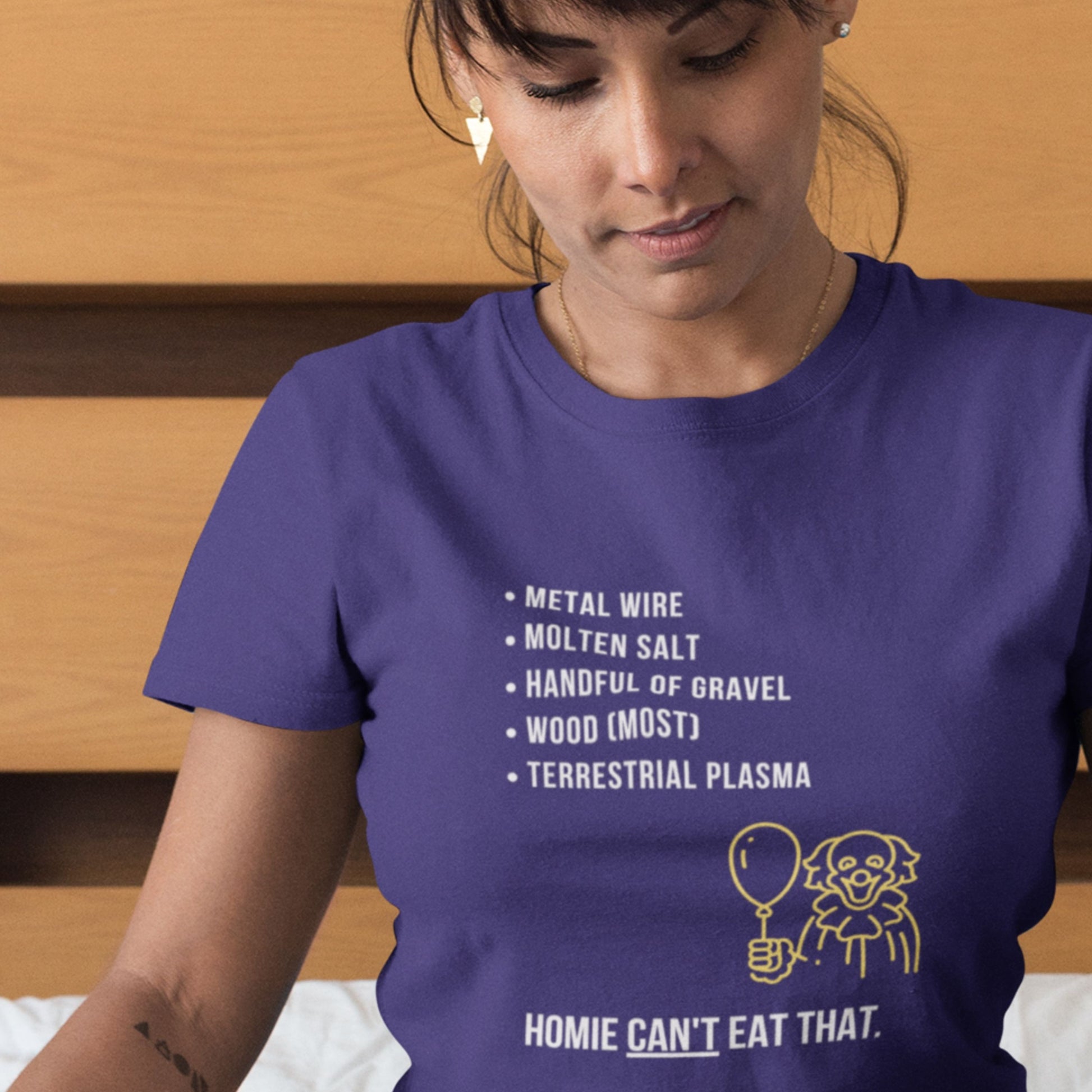 Person wearing a navy blue t-shirt with a humorous graphic and text.