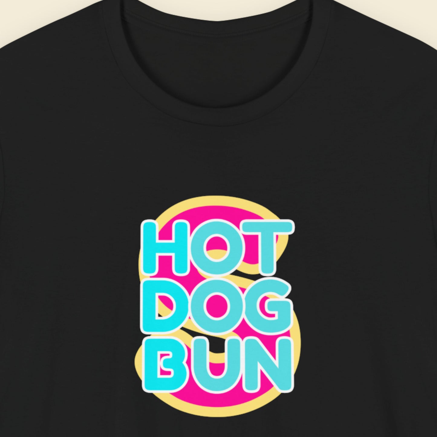 Black t-shirt with a fun, colorful cartoon illustration on a beige background.