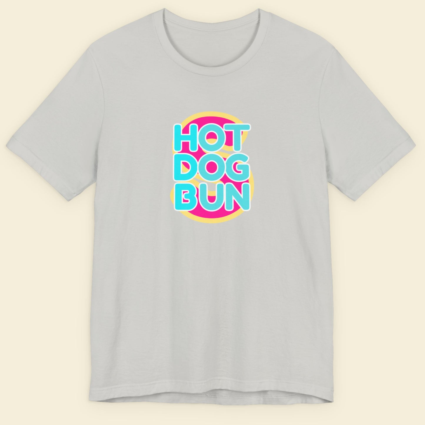 Gray t-shirt with 'Hot Dog Bun' colorful text design on a beige background.