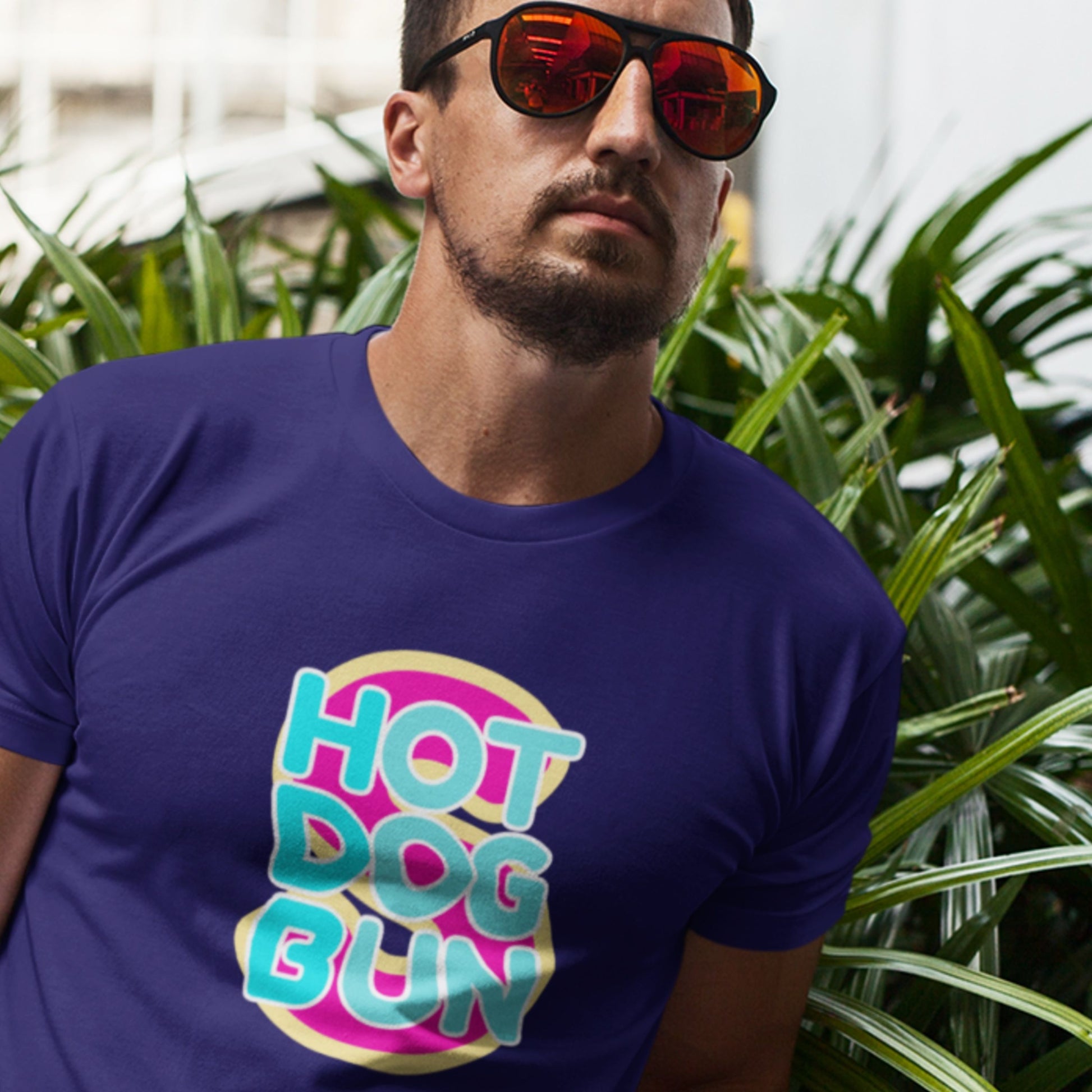 Cool guy wearing a navy blue t-shirt with a fun, colorful illustration in a zoo.