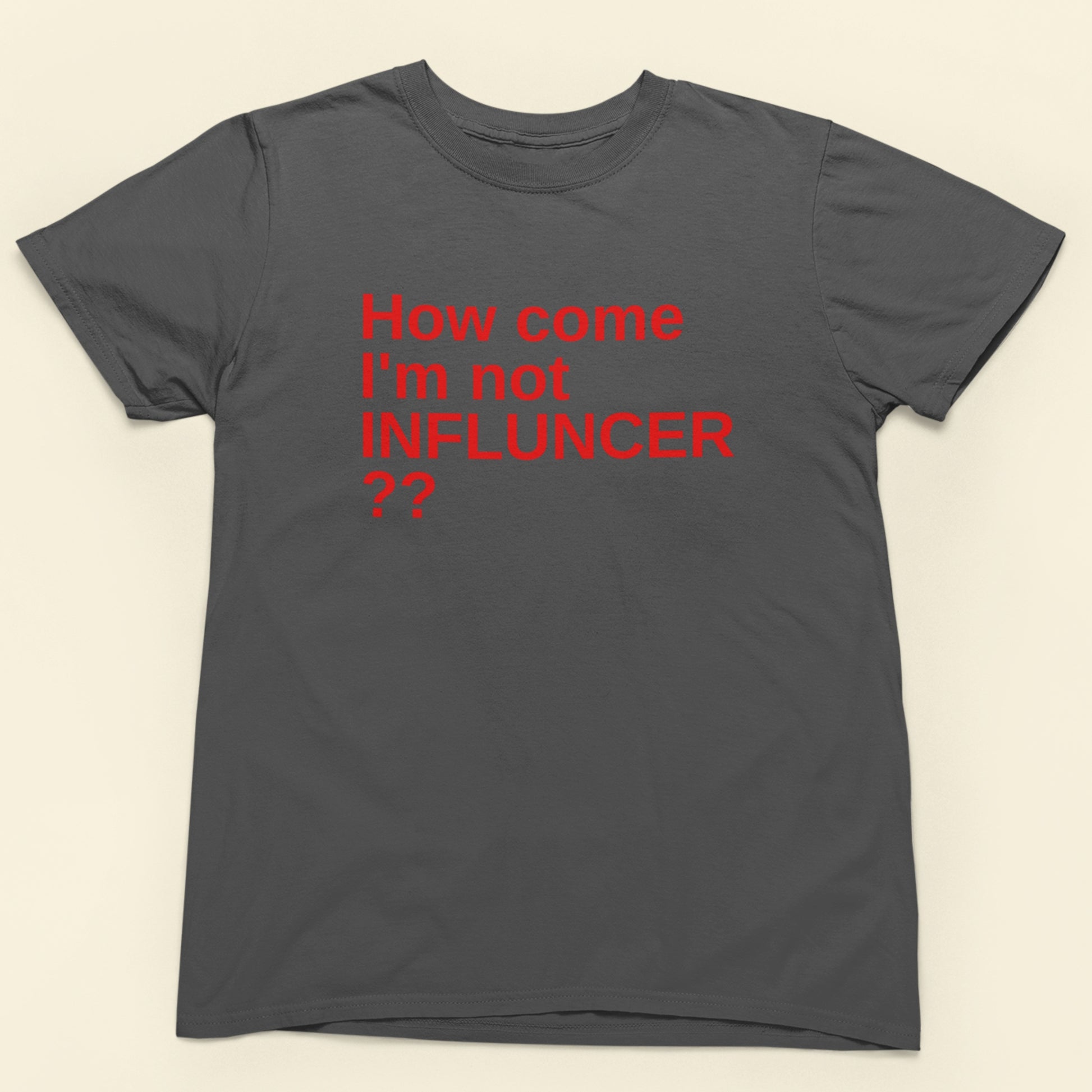 Gray t-shirt with red text 'How come I'm not INFLUNCER ??' on a beige background