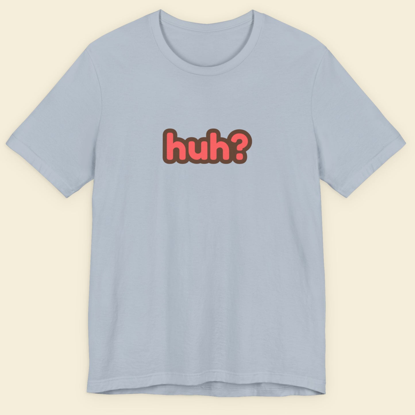 Light blue t-shirt with multicolored 'huh?' text on a beige background.