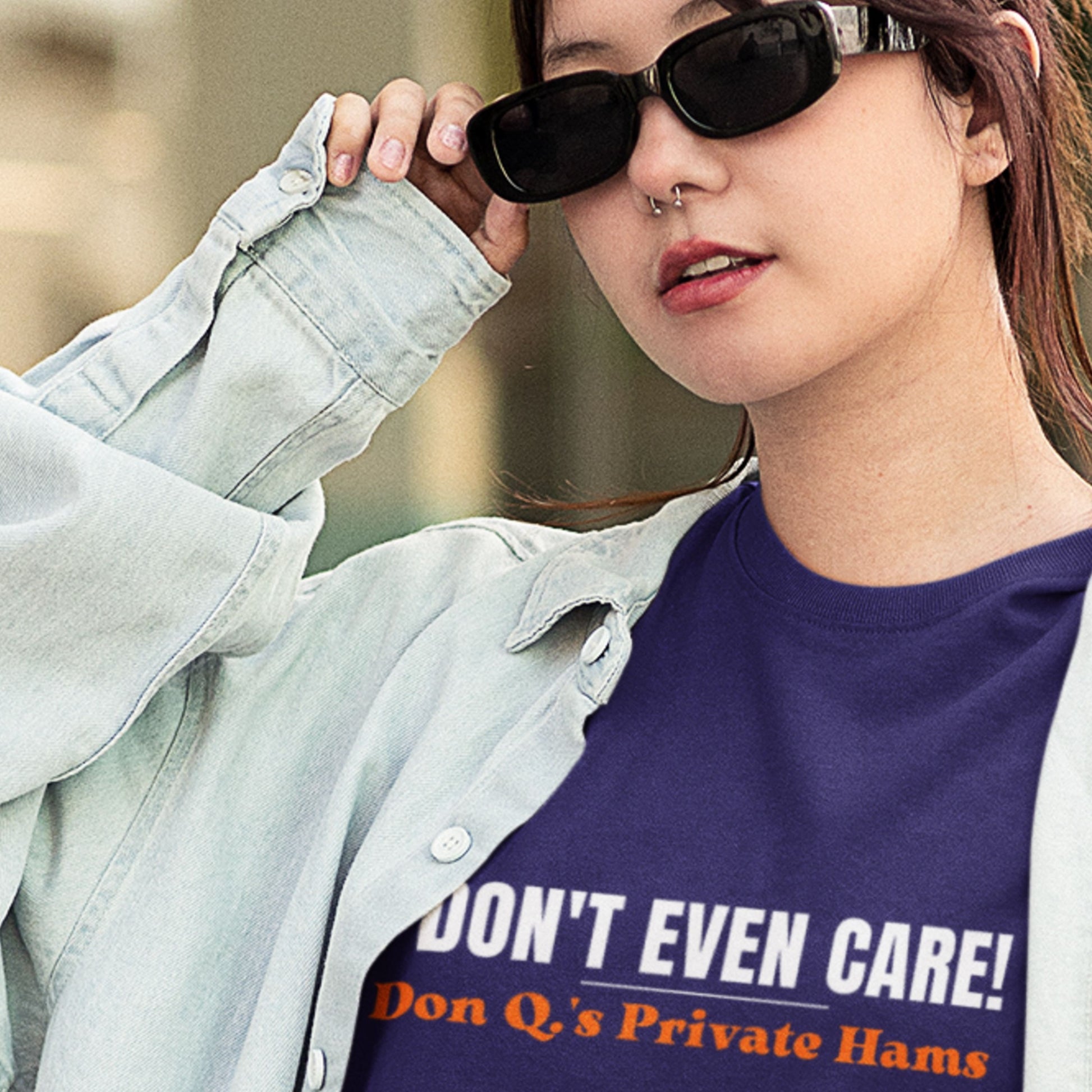 Person wearing a shirt with text 'I DON'T EVEN CARE! Don Q's Private Hams' outdoors.