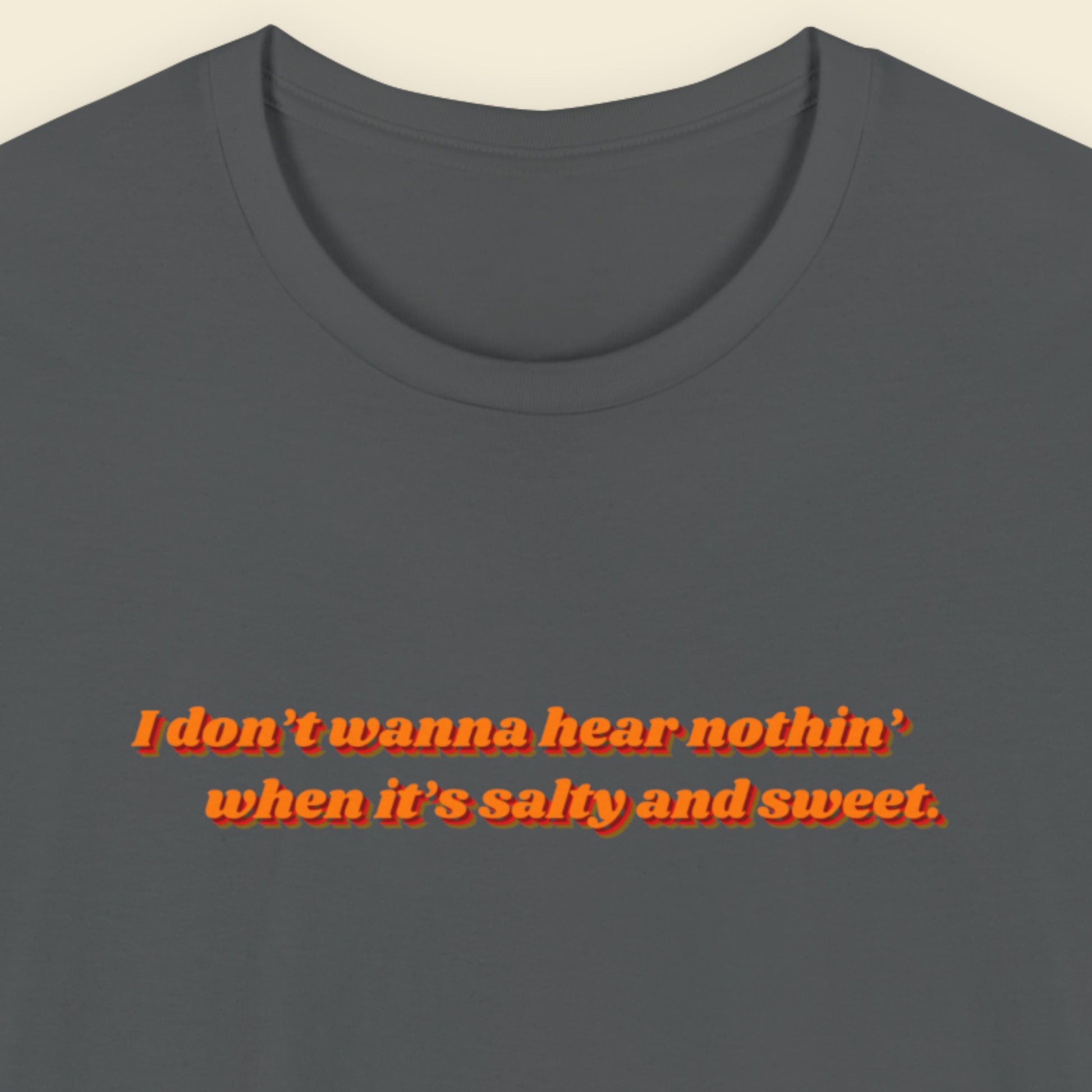 Gray t-shirt with red text on a beige background