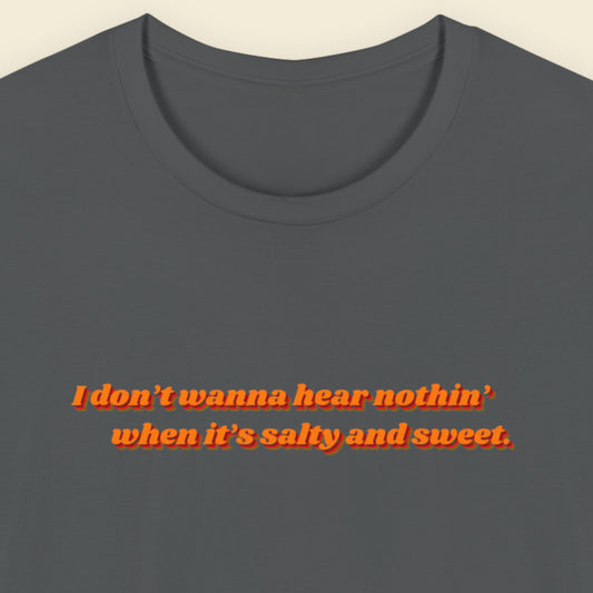 Gray t-shirt with red text on a beige background