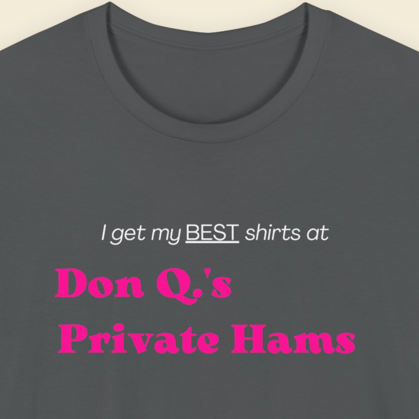 Grey t-shirt with humorous colorful text on a beige background.