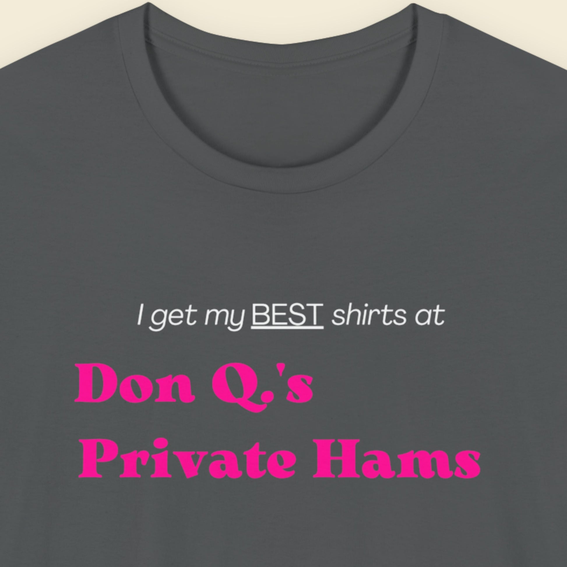 Grey t-shirt with humorous colorful text on a beige background.