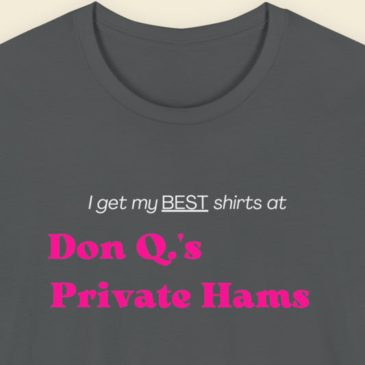 Grey t-shirt with humorous colorful text on a beige background.