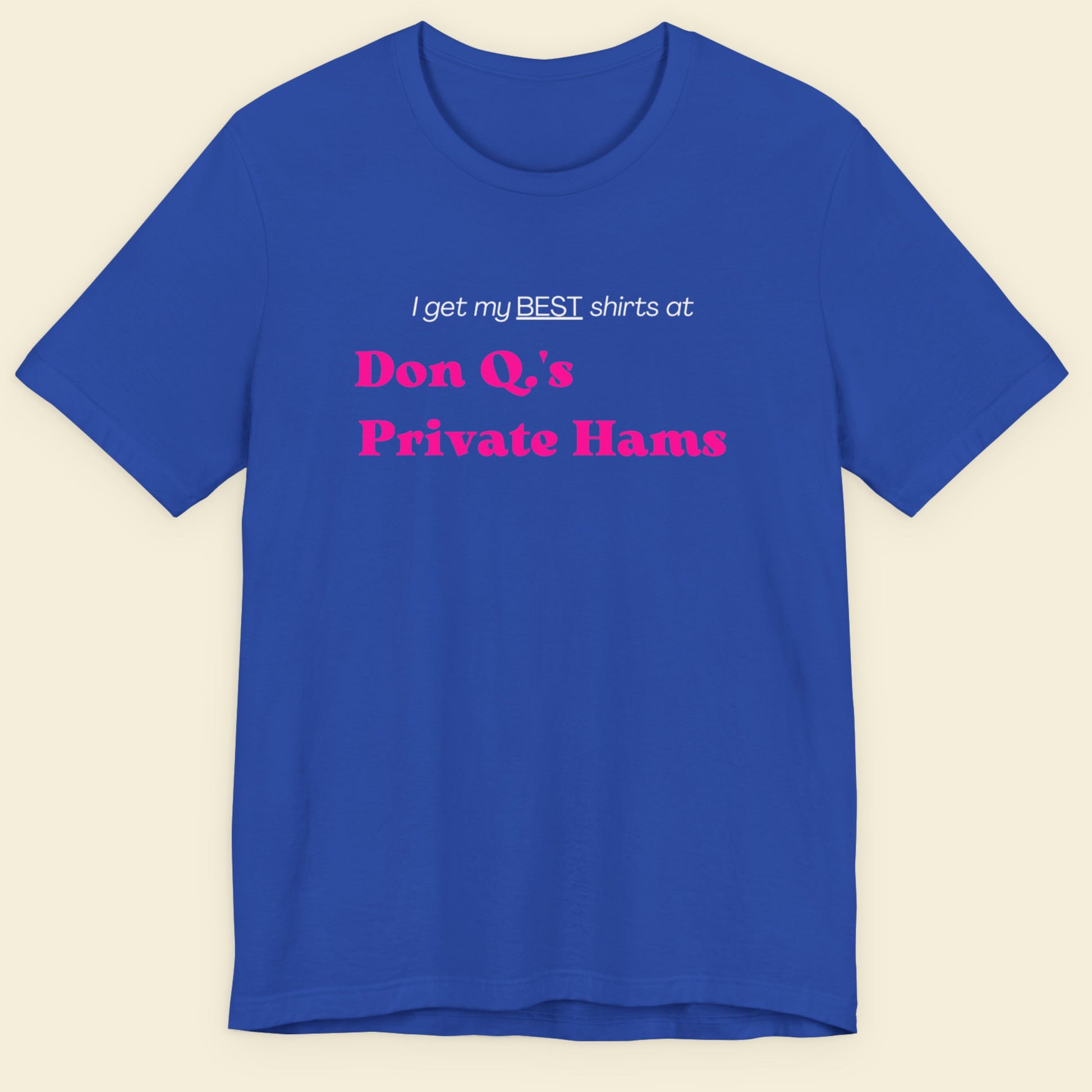 Blue t-shirt with humorous colorful text on a beige background.