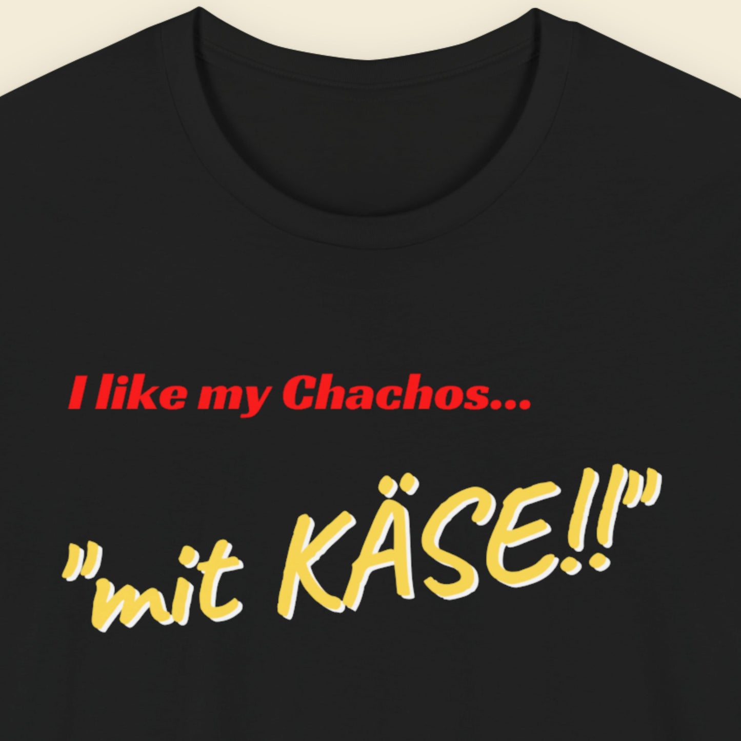 Black t-shirt with red and yellow text on a beige background.