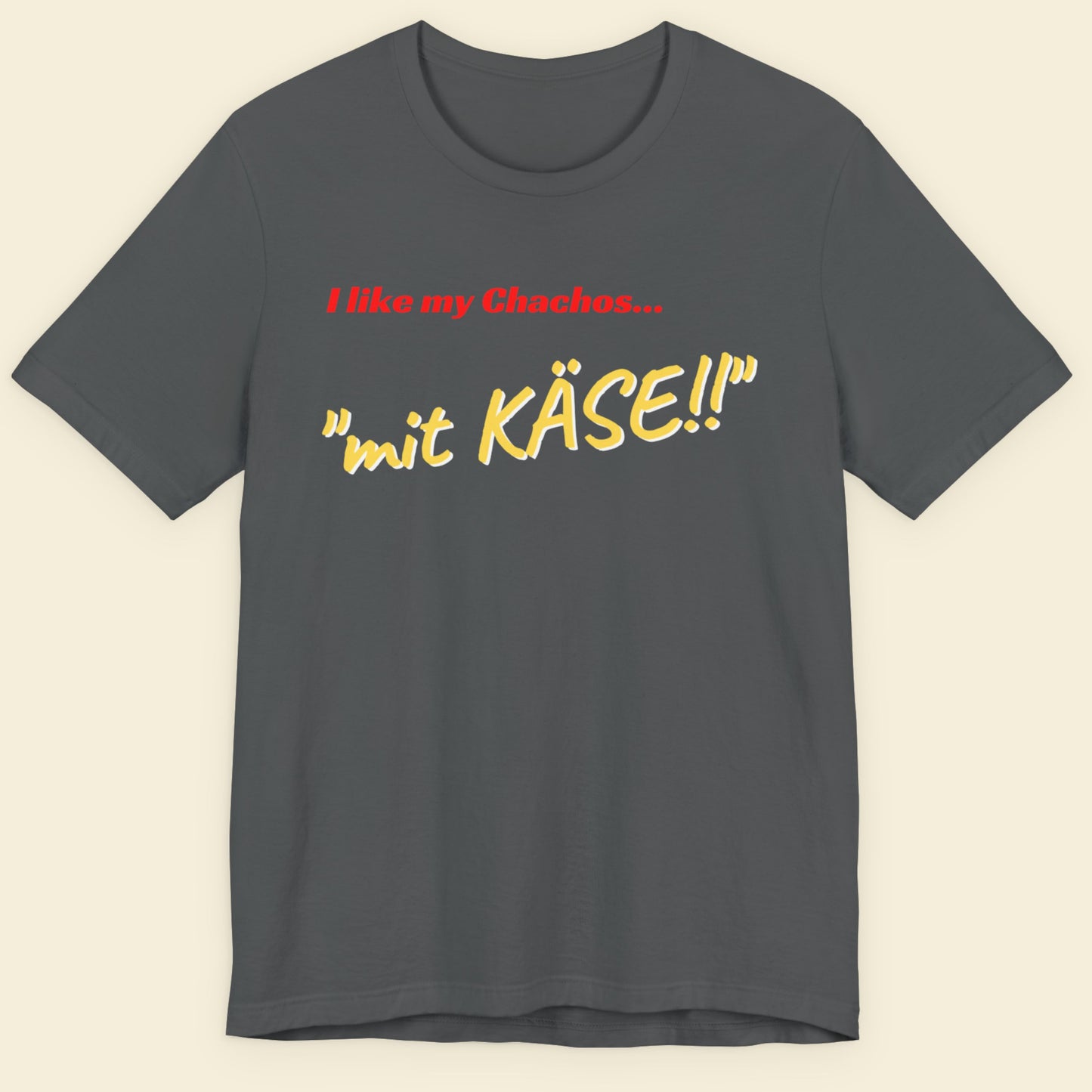 Gray t-shirt with text 'I like my Chachos... mit KASE!!' on a beige background.
