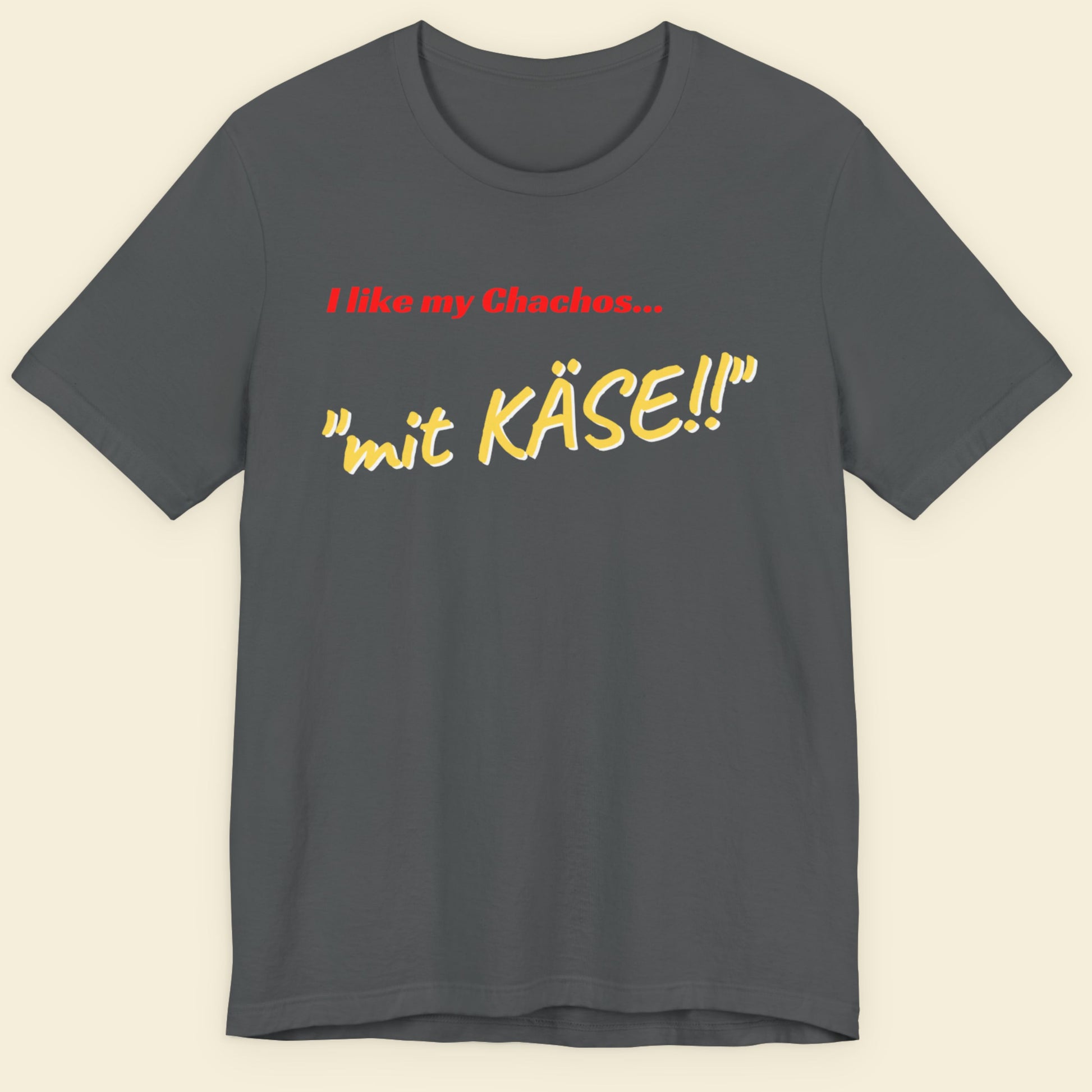 Gray t-shirt with text 'I like my Chachos... mit KASE!!' on a beige background.