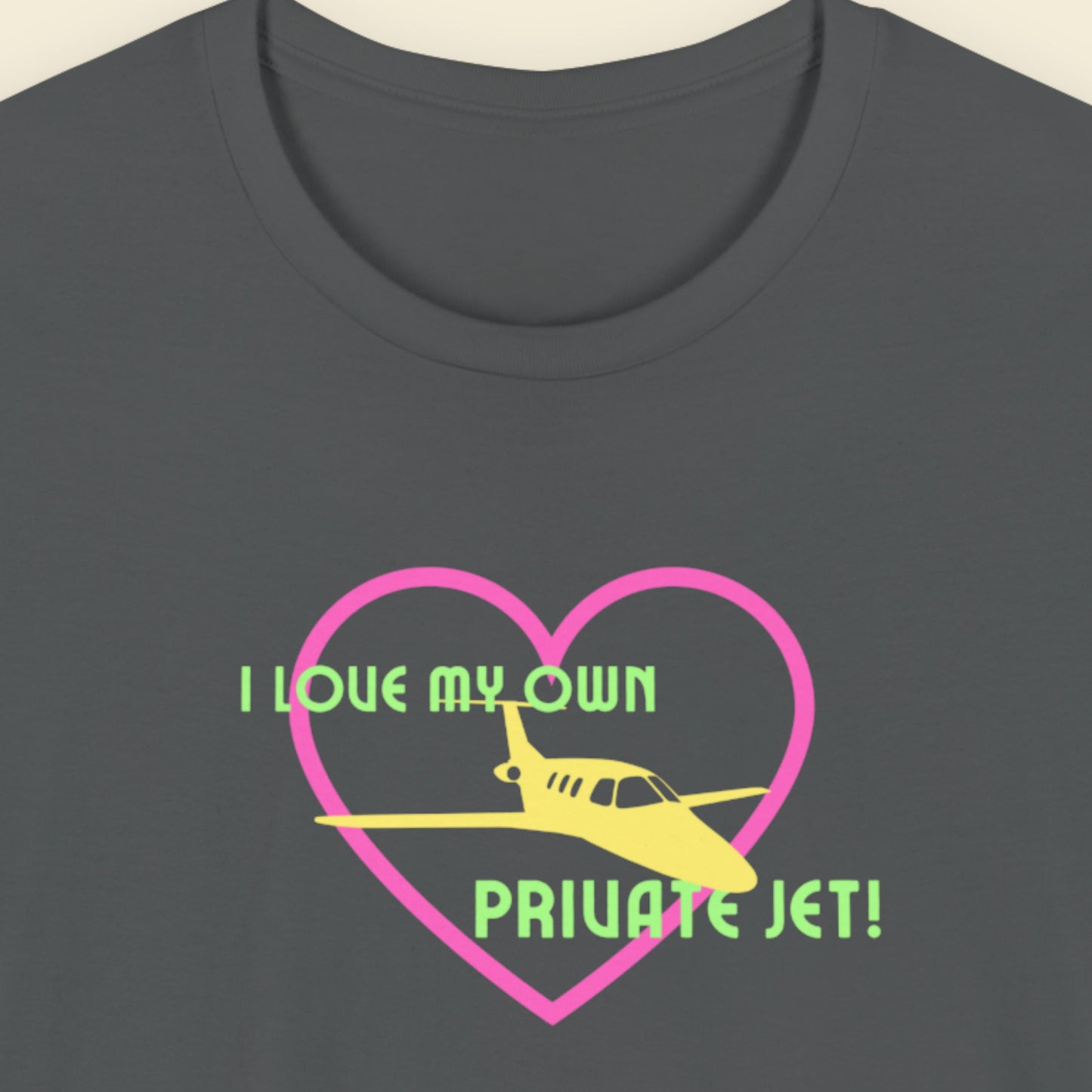 Grey t-shirt with a fun, colorful illustration on a beige background.