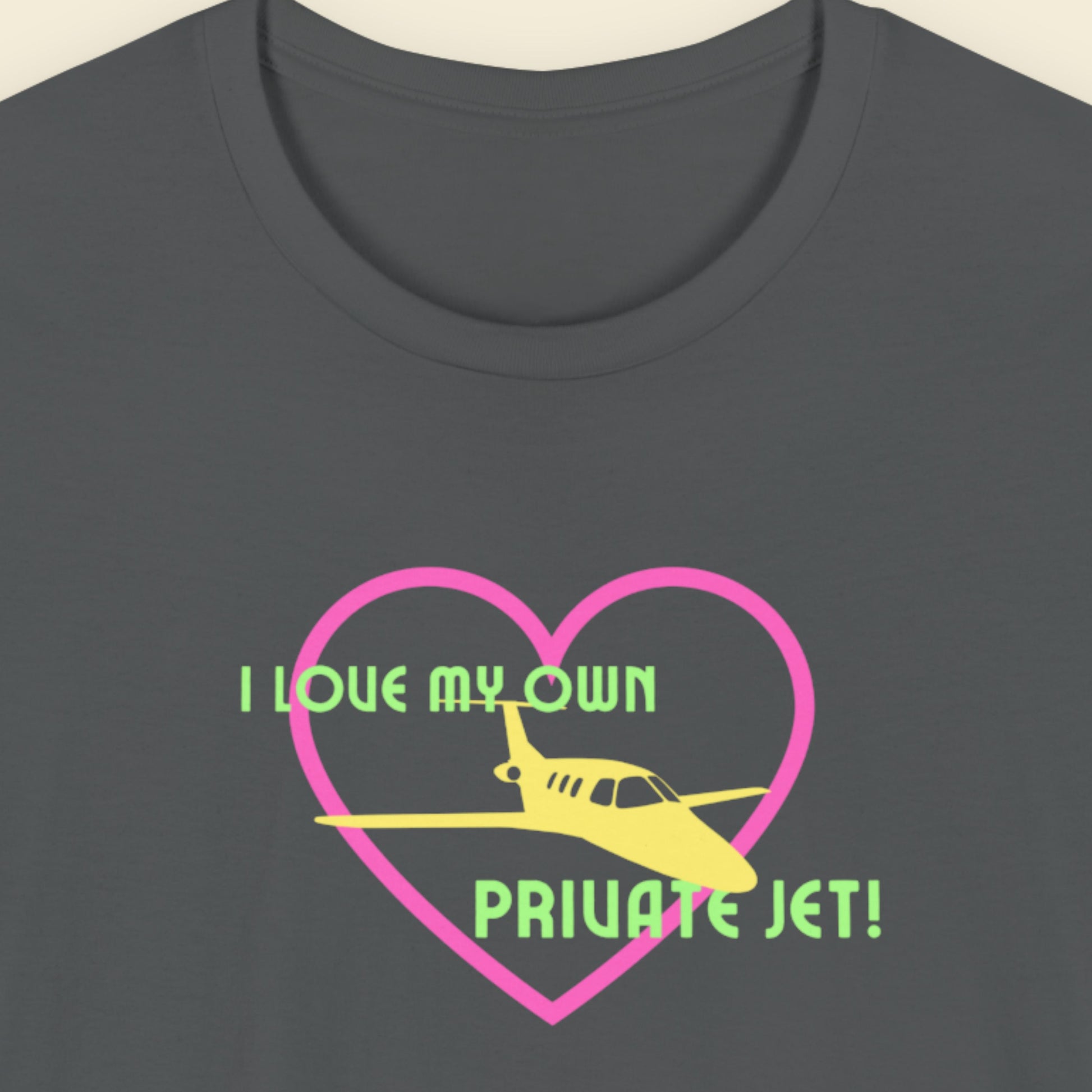 Grey t-shirt with a fun, colorful illustration on a beige background.