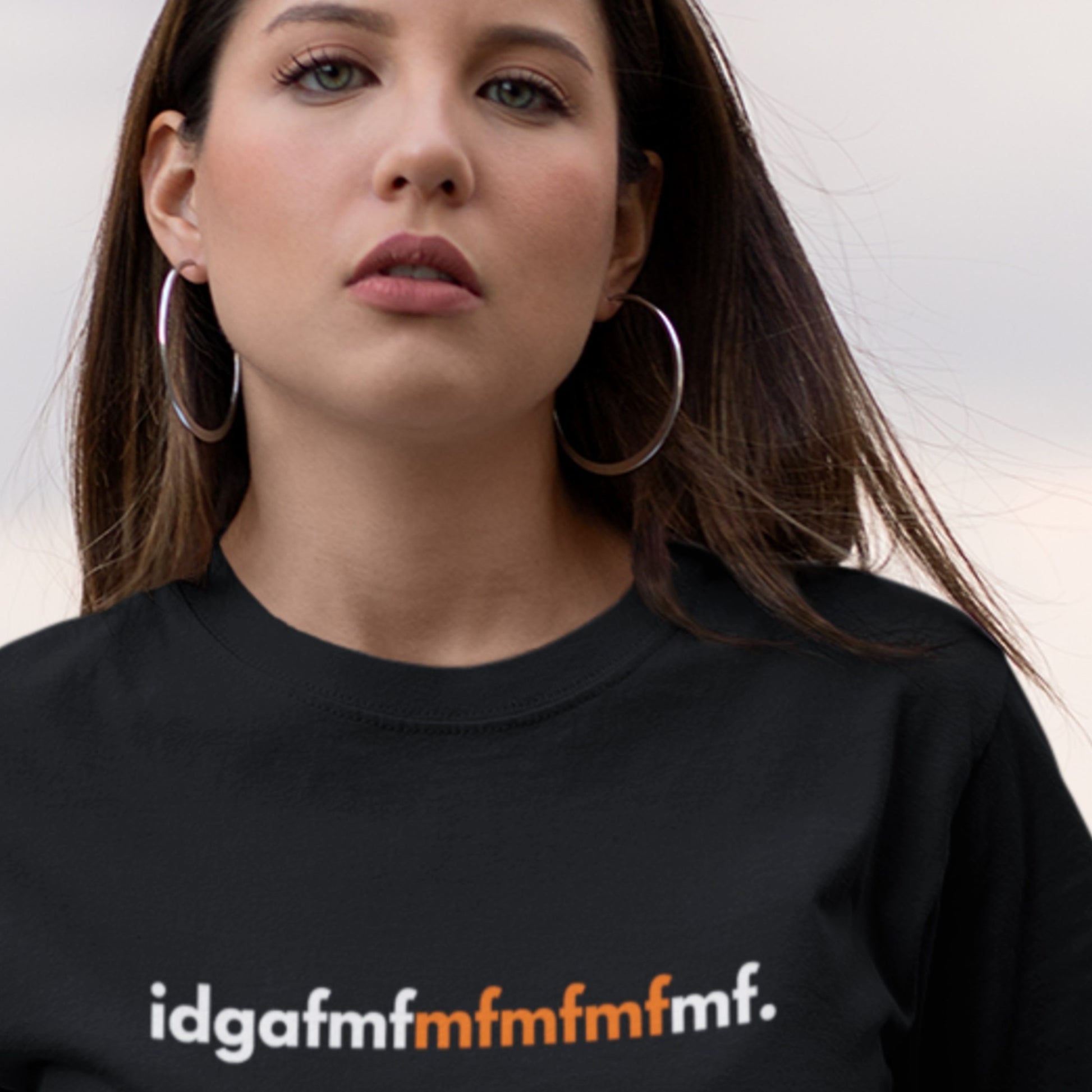 Person wearing a black t-shirt with 'idgafmfmfmfmf' text.