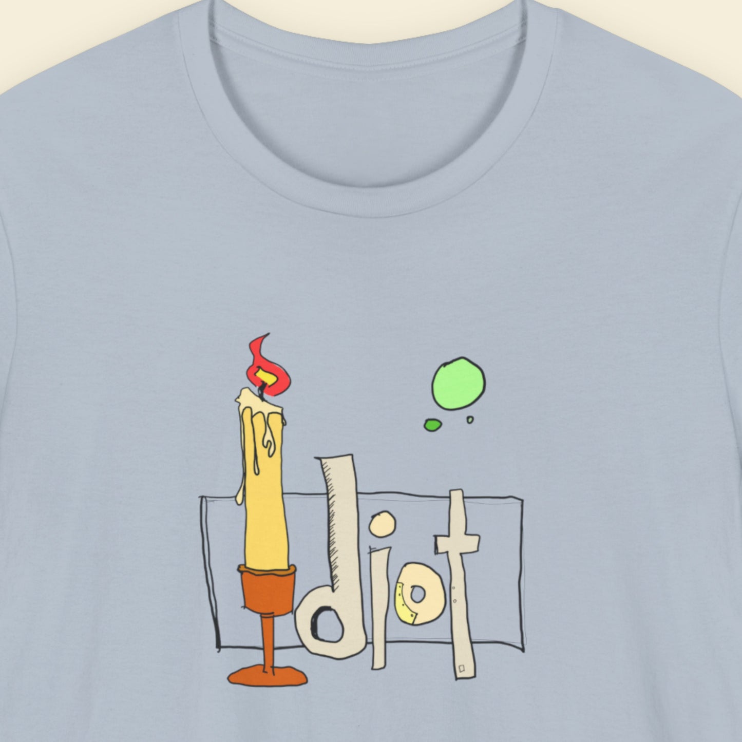 Light blue t-shirt with a colorful abstract comic book style drawing on a beige background.