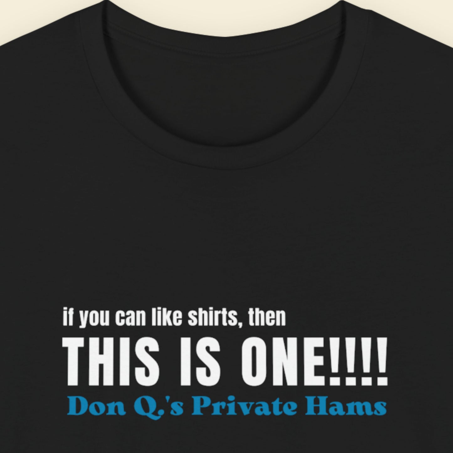 Black t-shirt with humorous colorful text on a beige background.