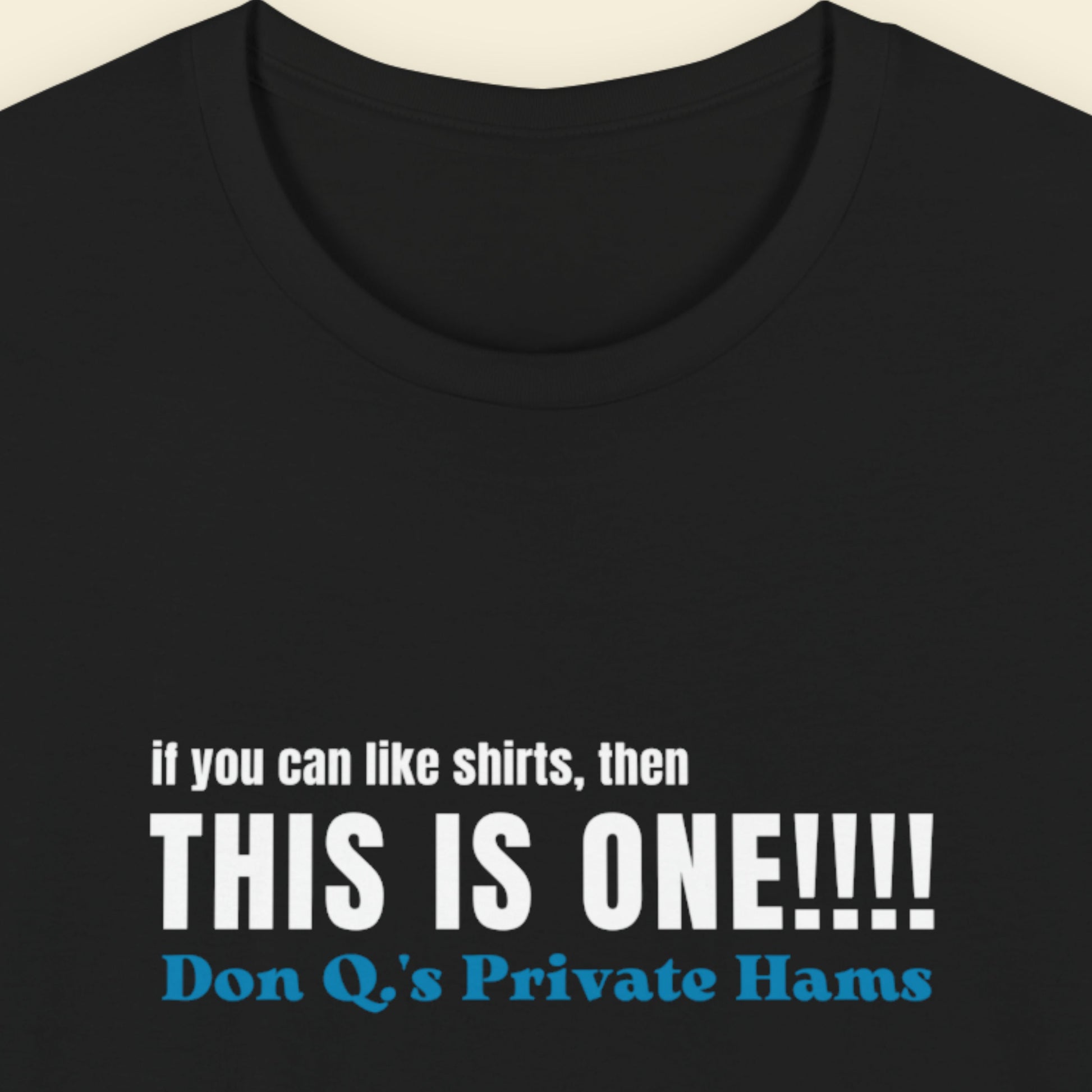 Black t-shirt with humorous colorful text on a beige background.
