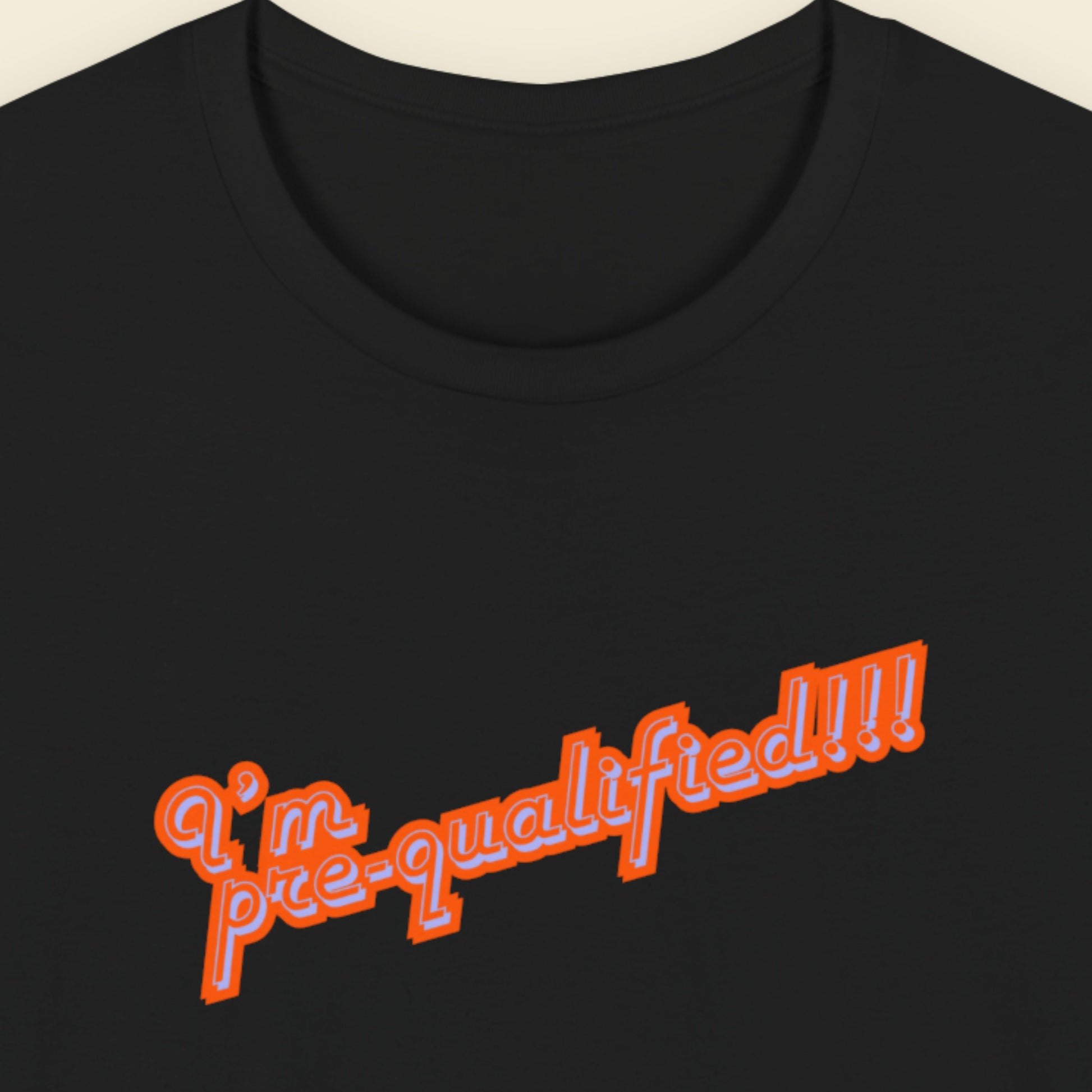 Black t-shirt with multicolored text reading 'I'm pre-qualified!!!' on a beige background.