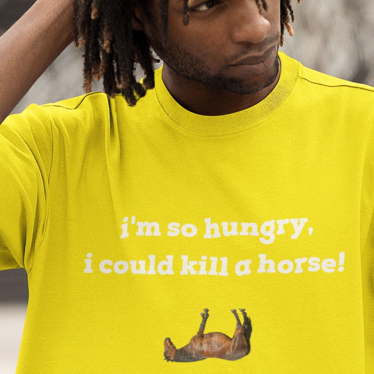 Person wearing a yellow t-shirt with humorous text and graphic.
