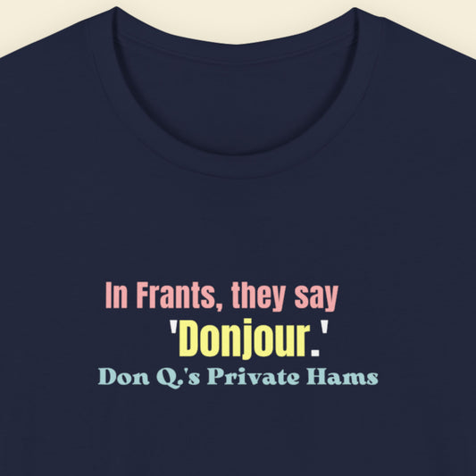 Navy blue t-shirt with humorous colorful text on a beige background.