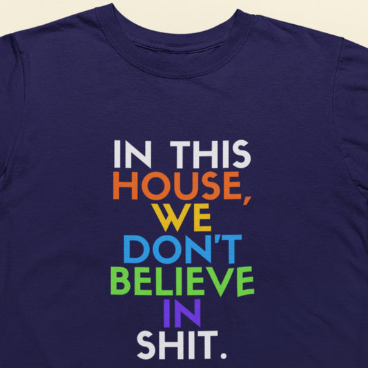 Navy blue t-shirt with colorful text on a beige background