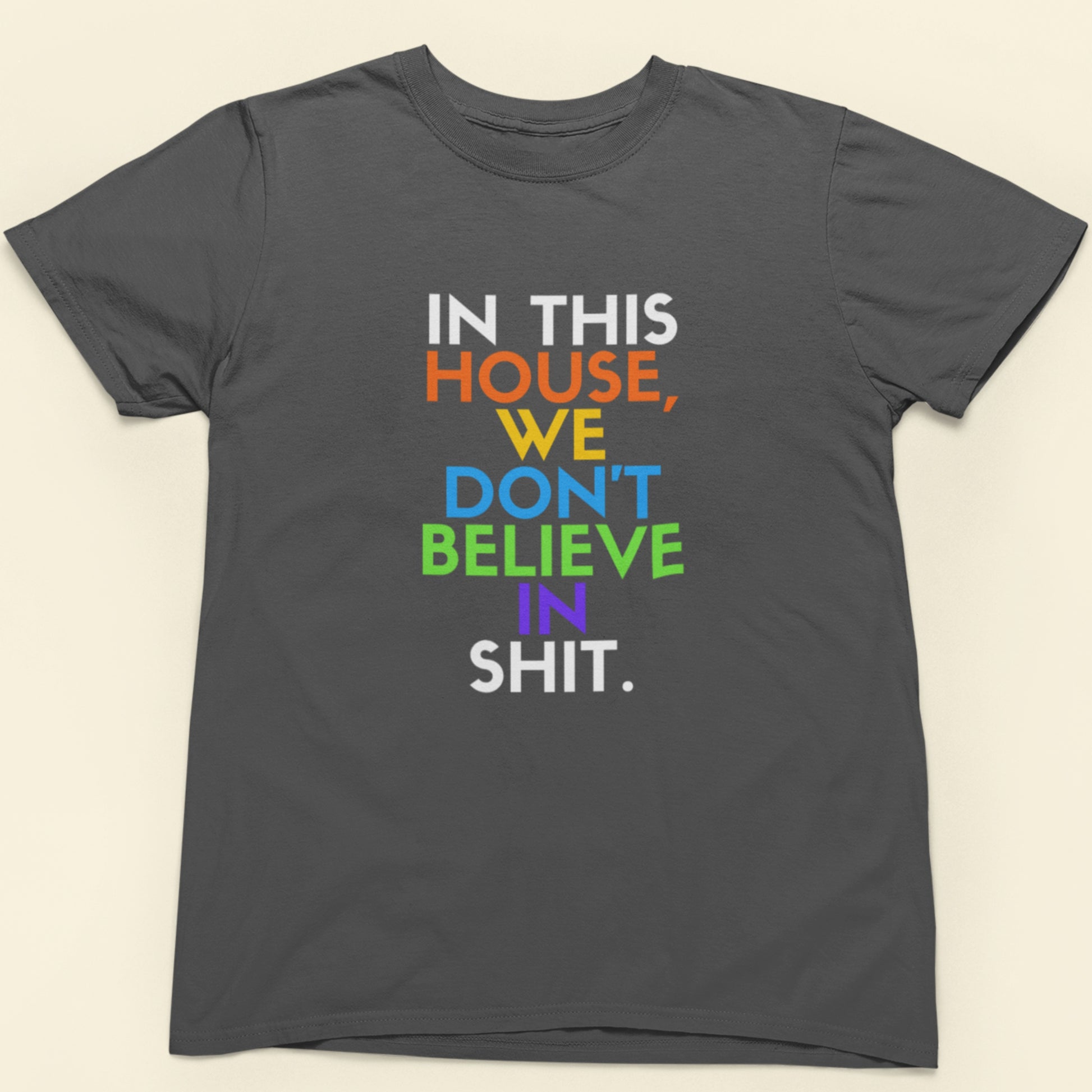 Gray t-shirt with colorful text on a beige background