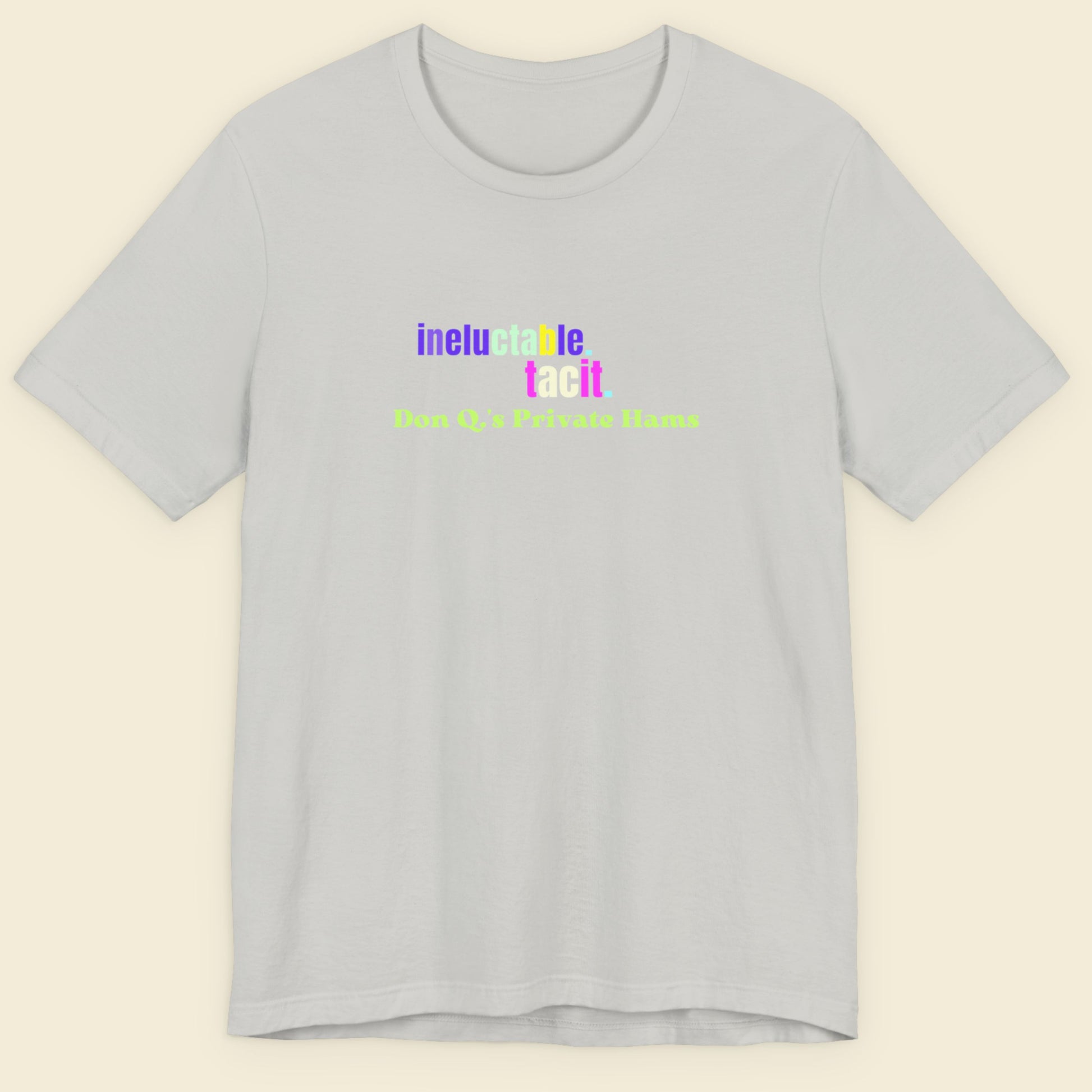 Gray t-shirt with colorful text on a beige background.
