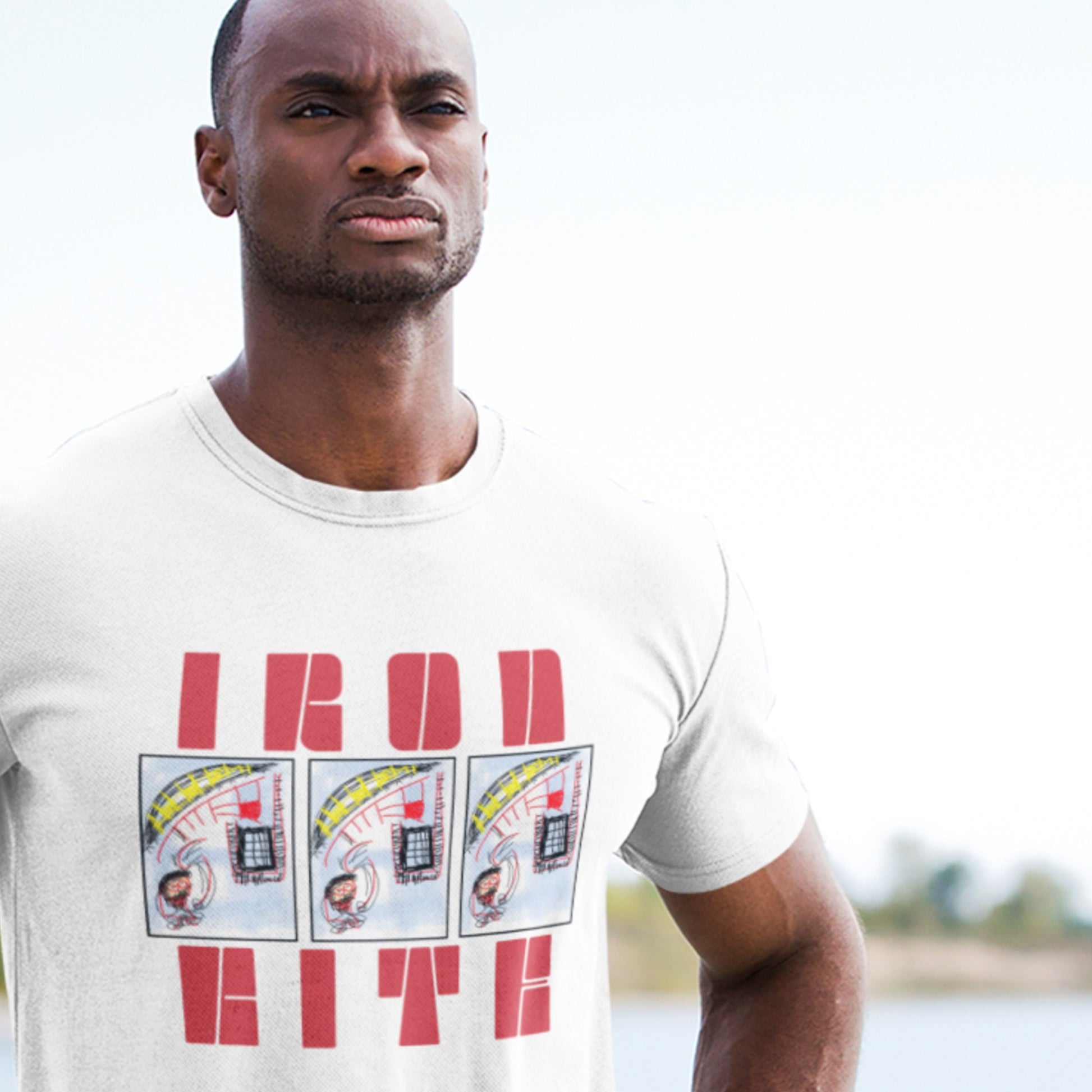 Man wearing a white t-shirt with a graphic design outdoors.