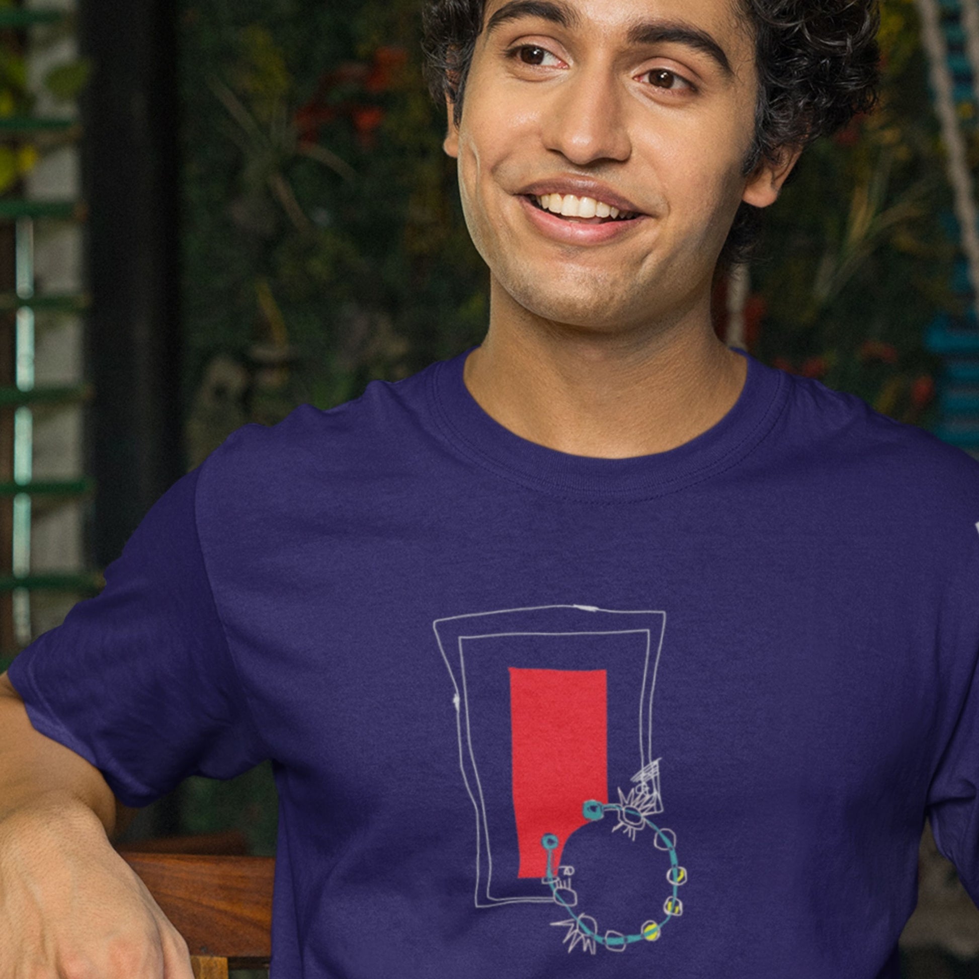Man wearing a blue t-shirt with a red and white graphic design.