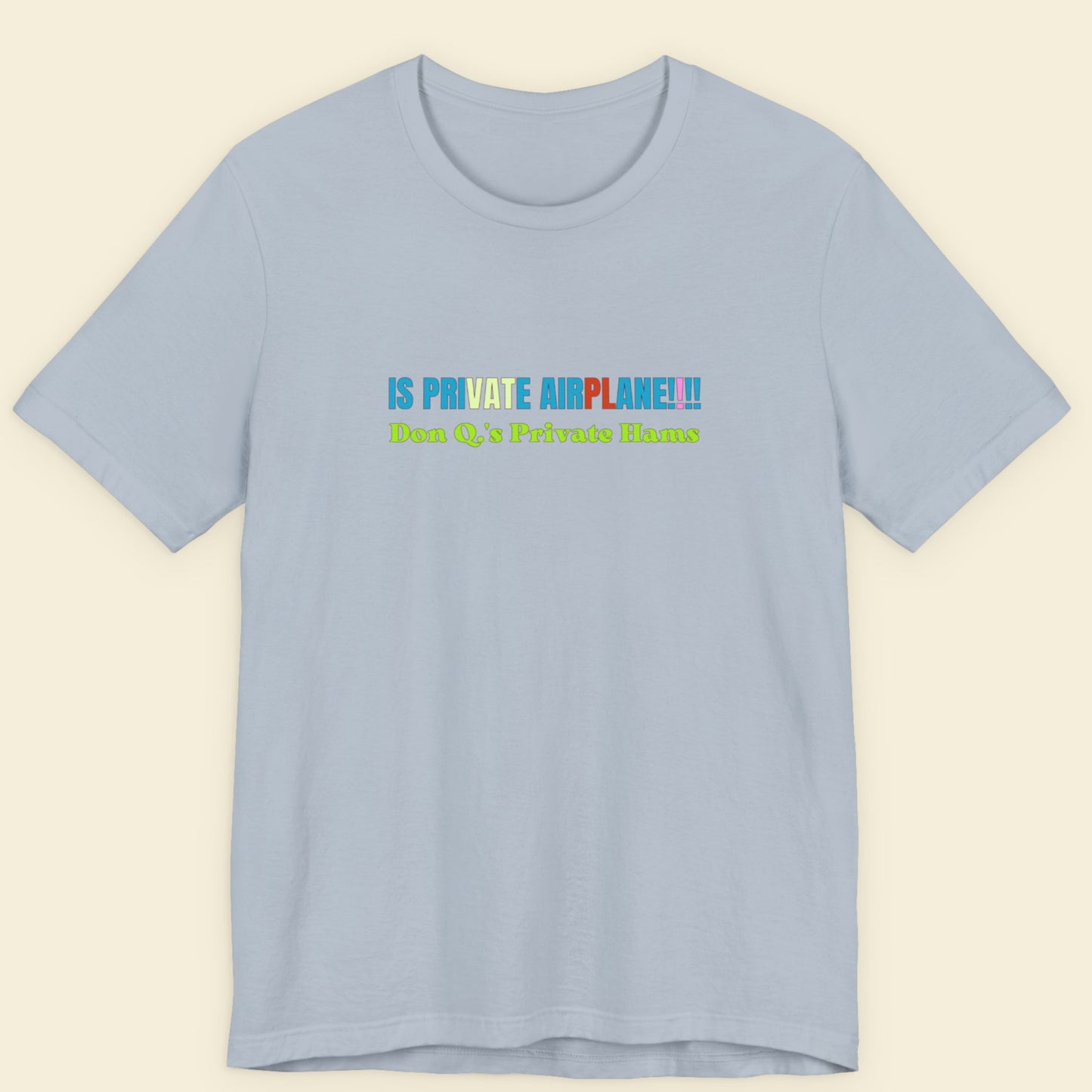 Light blue t-shirt with colorful text on a beige background