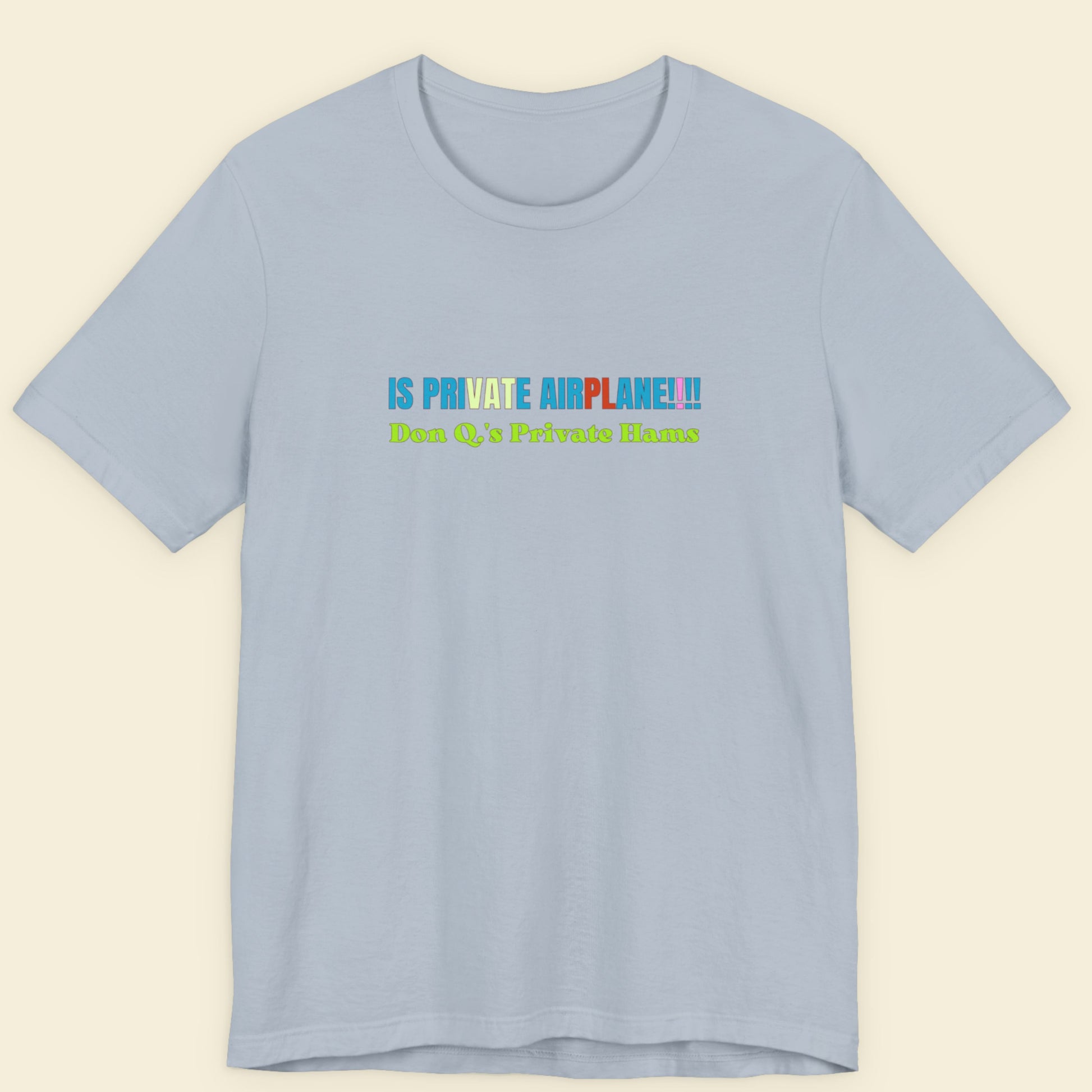 Light blue t-shirt with colorful text on a beige background